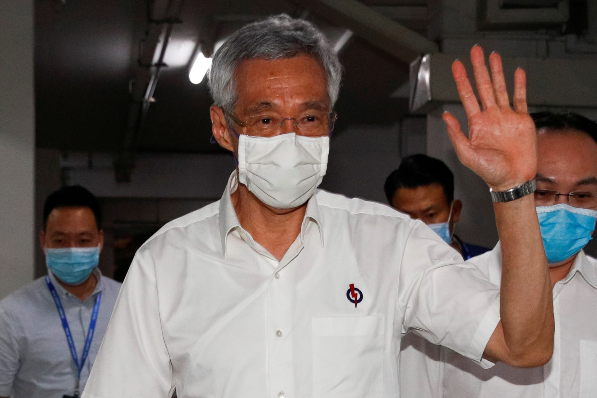 <p>Singapore’s Prime Minister Lee Hsien Loong waves as he arrives at a People’s Action Party branch office, as ballots are being counted during the general election, in Singapore on July 11, 2020.</p>
