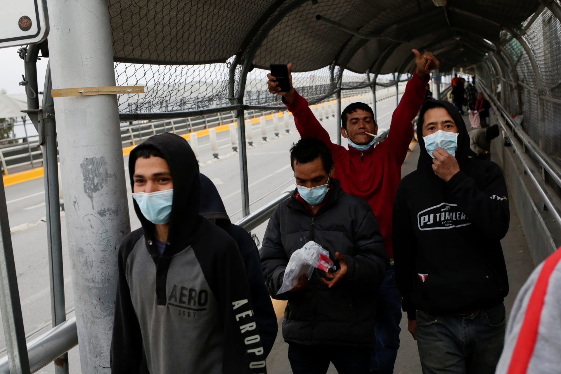 <p>Mexican migrants deported from the U.S. are pictured at Paso del Norte International Border bridge after the U.S. and Mexico have agreed to restrict non-essential travel over their shared border to limit the spread of coronavirus disease (COVID-19).</p>
