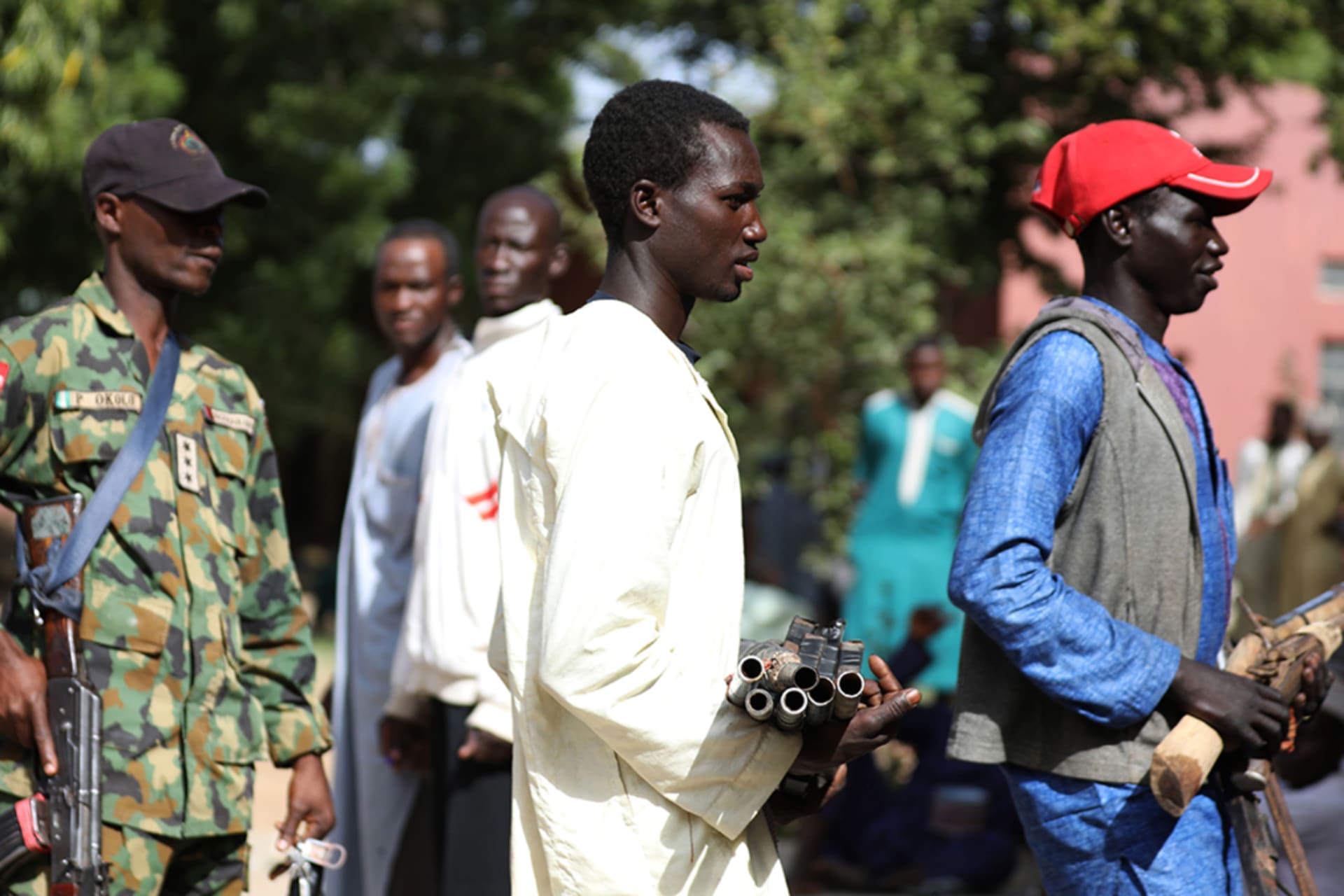 <p>Members of the Yansakai vigilante group bring their weapons into a government building as members surrendered more than five hundred guns to Zamfara Governor Bello Matawalle as part of a peace process, in Gusau, Zamfara, Nigeria, on December 3, 2019.</p>
