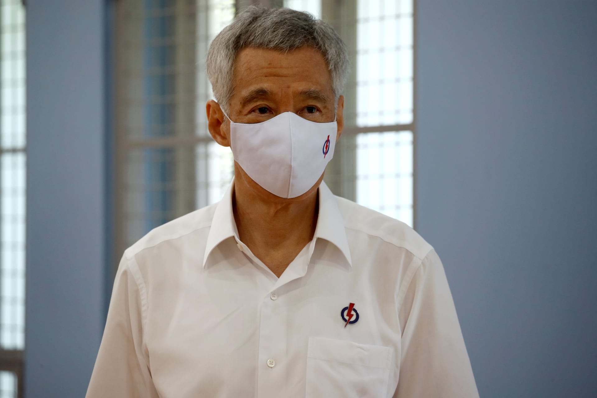<p>Singapore’s Prime Minister Lee Hsien Loong of the ruling People’s Action Party, wearing a face mask, prepares to give a speech at a nomination center ahead of the general election in Singapore on June 30, 2020.</p>
