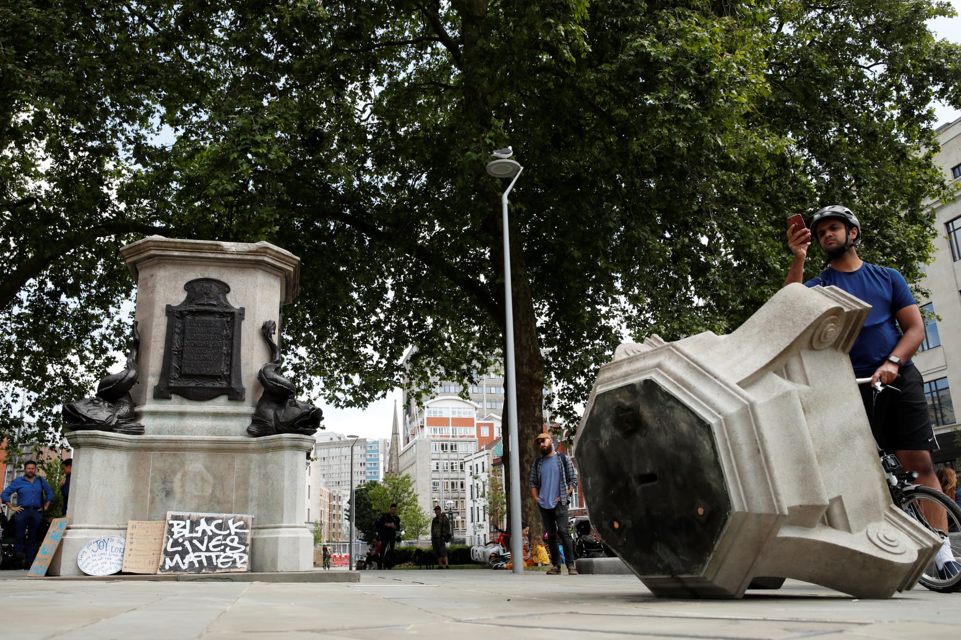 <p>A man observes the base of the statue of Edward Colston, after protesters pulled it down and pushed into the docks, following the death of George Floyd who died in police custody in Minneapolis, Bristol, Britain, June 8, 2020.</p>
