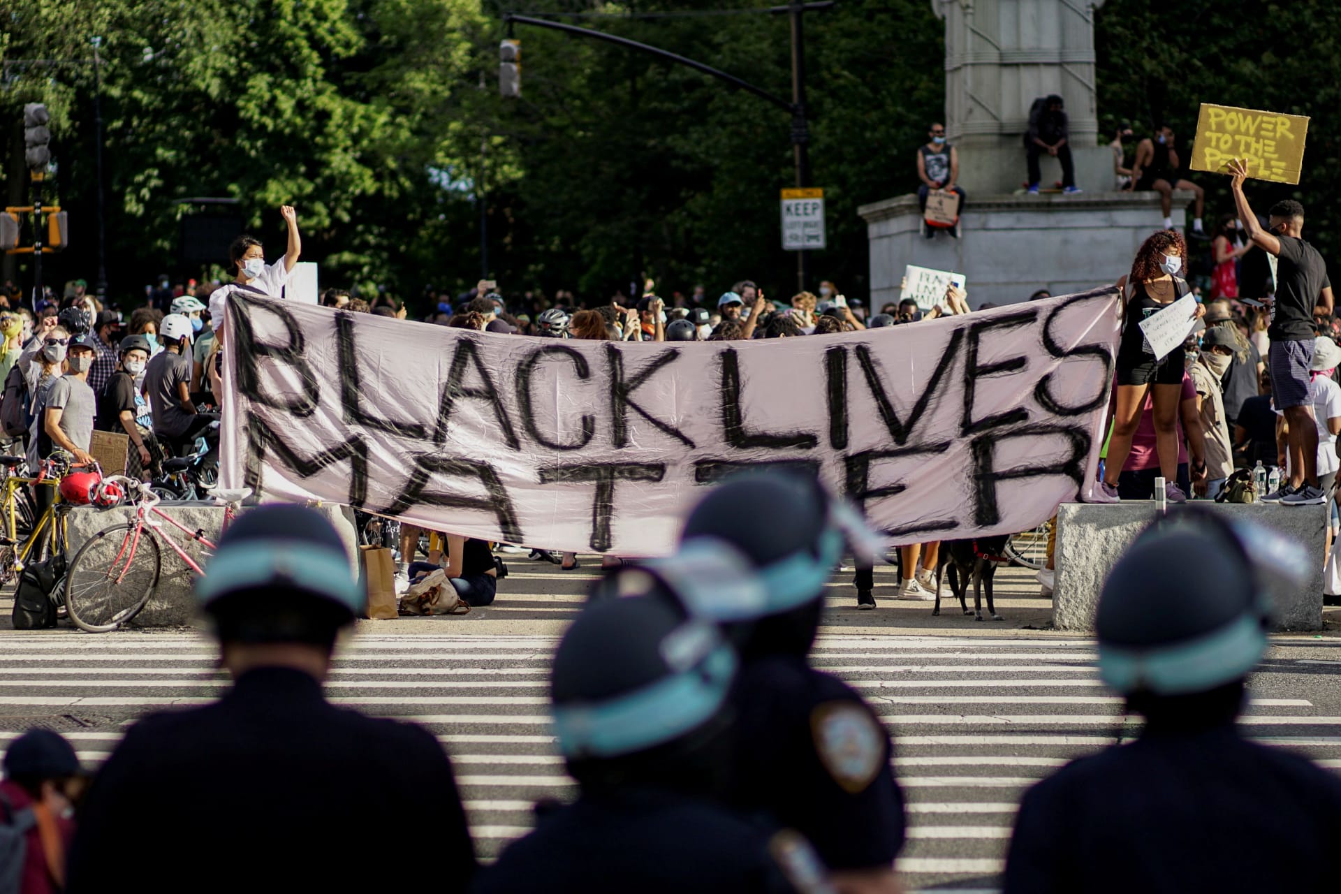 <p>Demonstrators hold a Black Lives Matter banner during a protest against racial inequality in New York City on June 7, 2020.</p>
