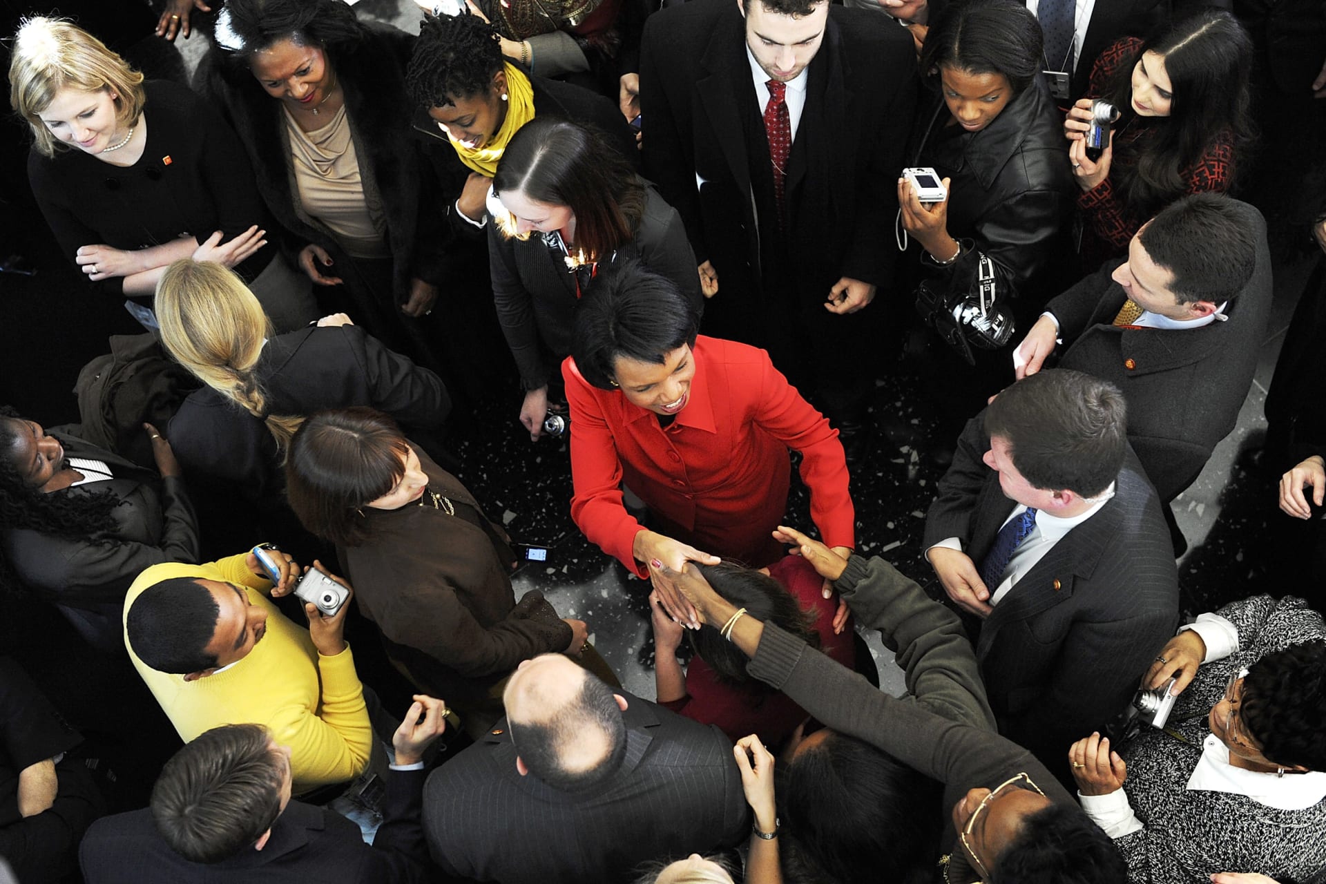 <p>U.S. Secretary of State Condoleezza Rice is surrounded as she bids farewell to a lobby filled with employees after her last day at the State Department in Washington, January 16, 2009. </p>
