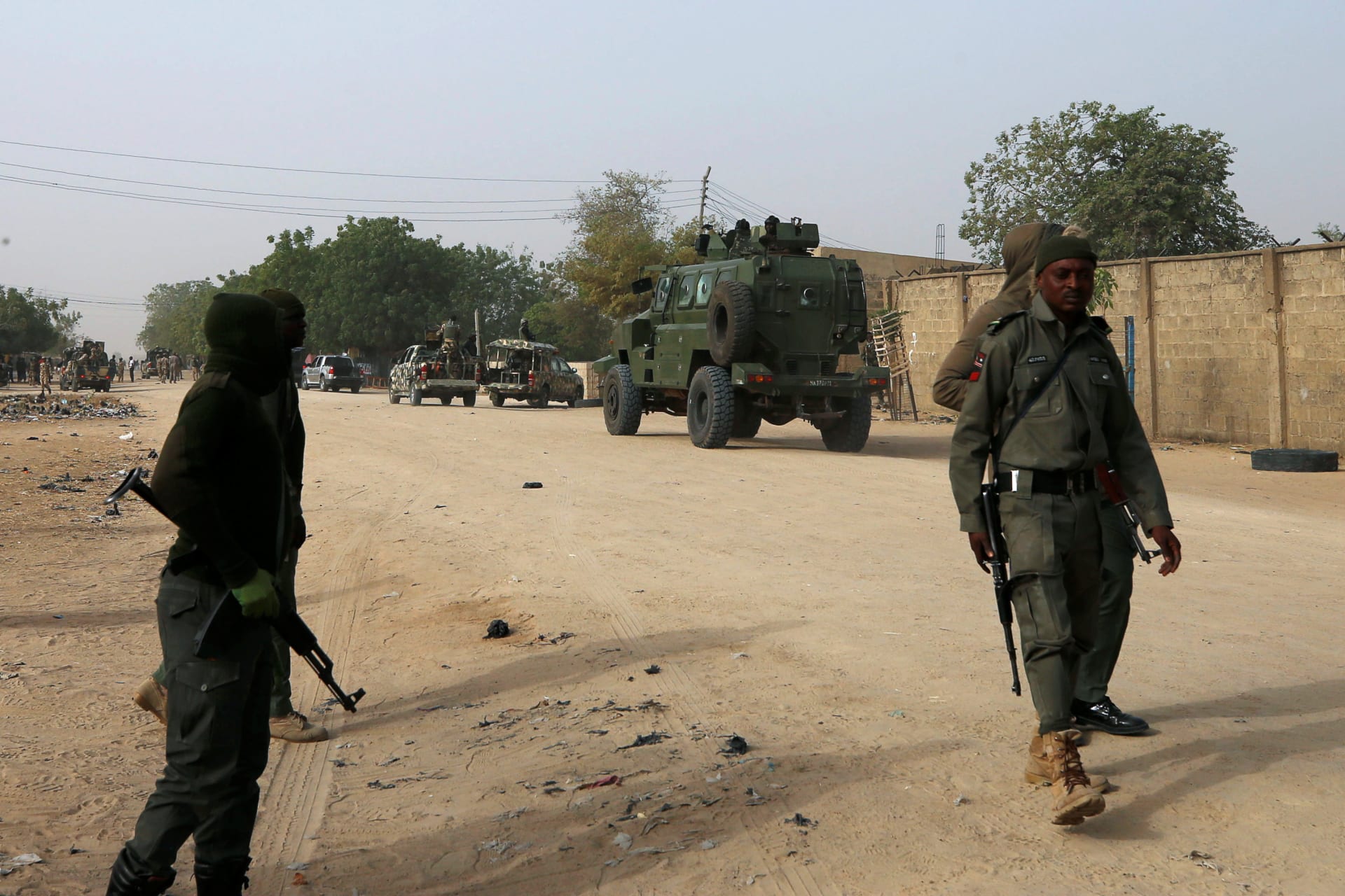 <p>Nigerian military personnel, pictured here on February 16, 2019, securing an area after a man was killed by suspected militants in Maiduguri, have been stretched thin, and are deployed in almost every Nigerian state. </p>
