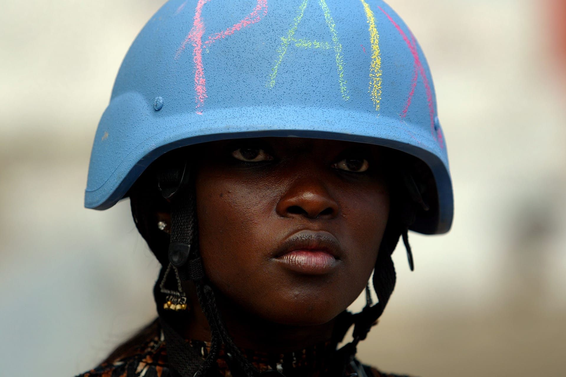 <p>A U.N. worker wears a U.N. helmet with the word “peace” written on it in Martissant, Haiti.</p>
