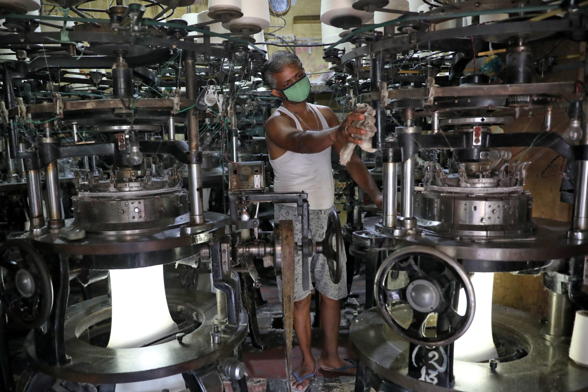 <p>A worker in a recently reopened undergarment factory in Kolkata, India.</p>
