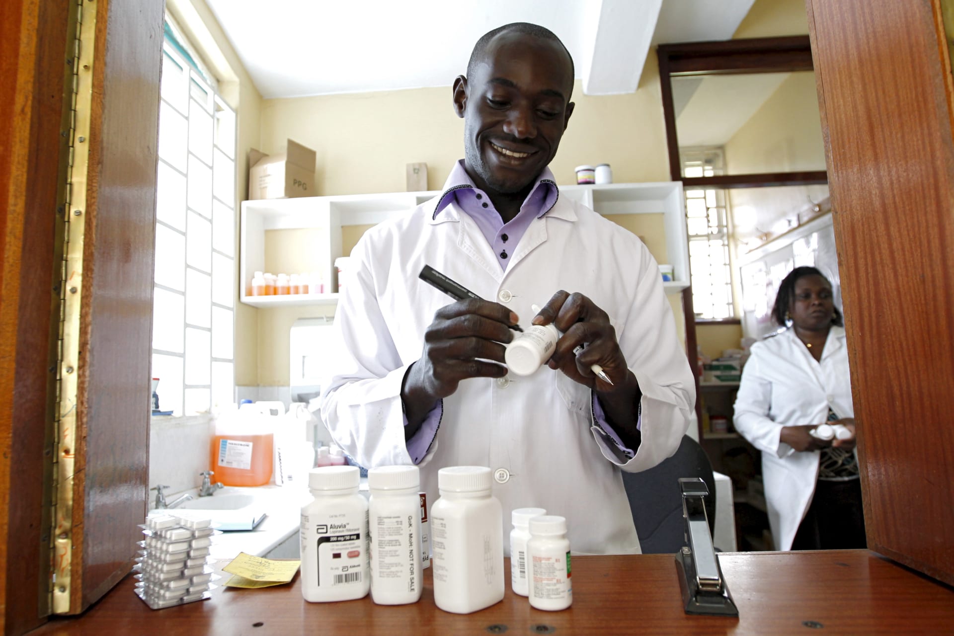 <p>Michael Otieno, a pharmacist, dispenses antiretroviral (ARV) drugs at the Mater Hospital in Kenya’s capital Nairobi, on September 10, 2015.</p>
