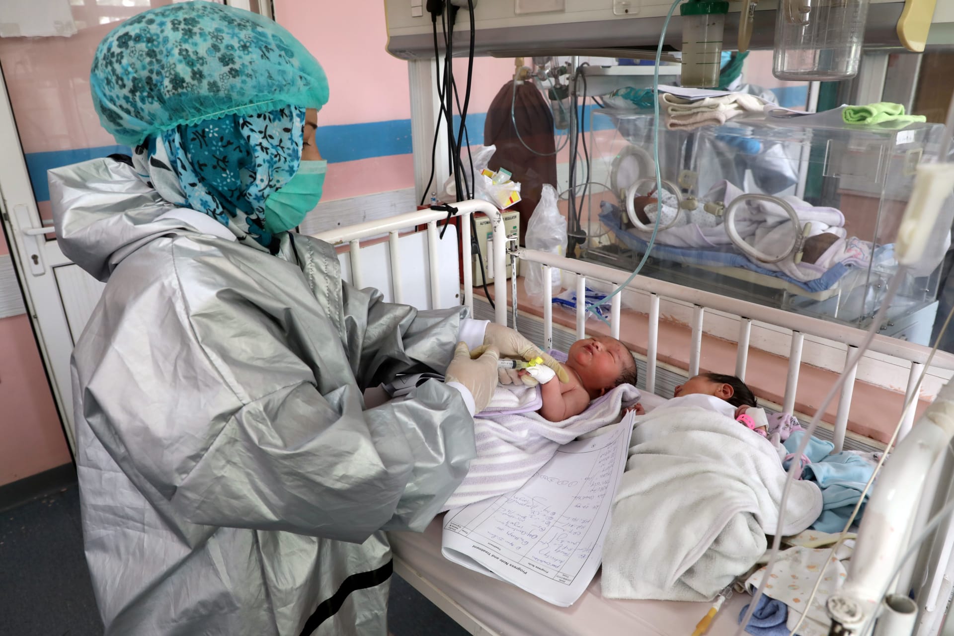 <p>An Afghan nurse observes newborn children who lost their mothers during an attack at a hospital, in Kabul, Afghanistan May 13, 2020.</p>
