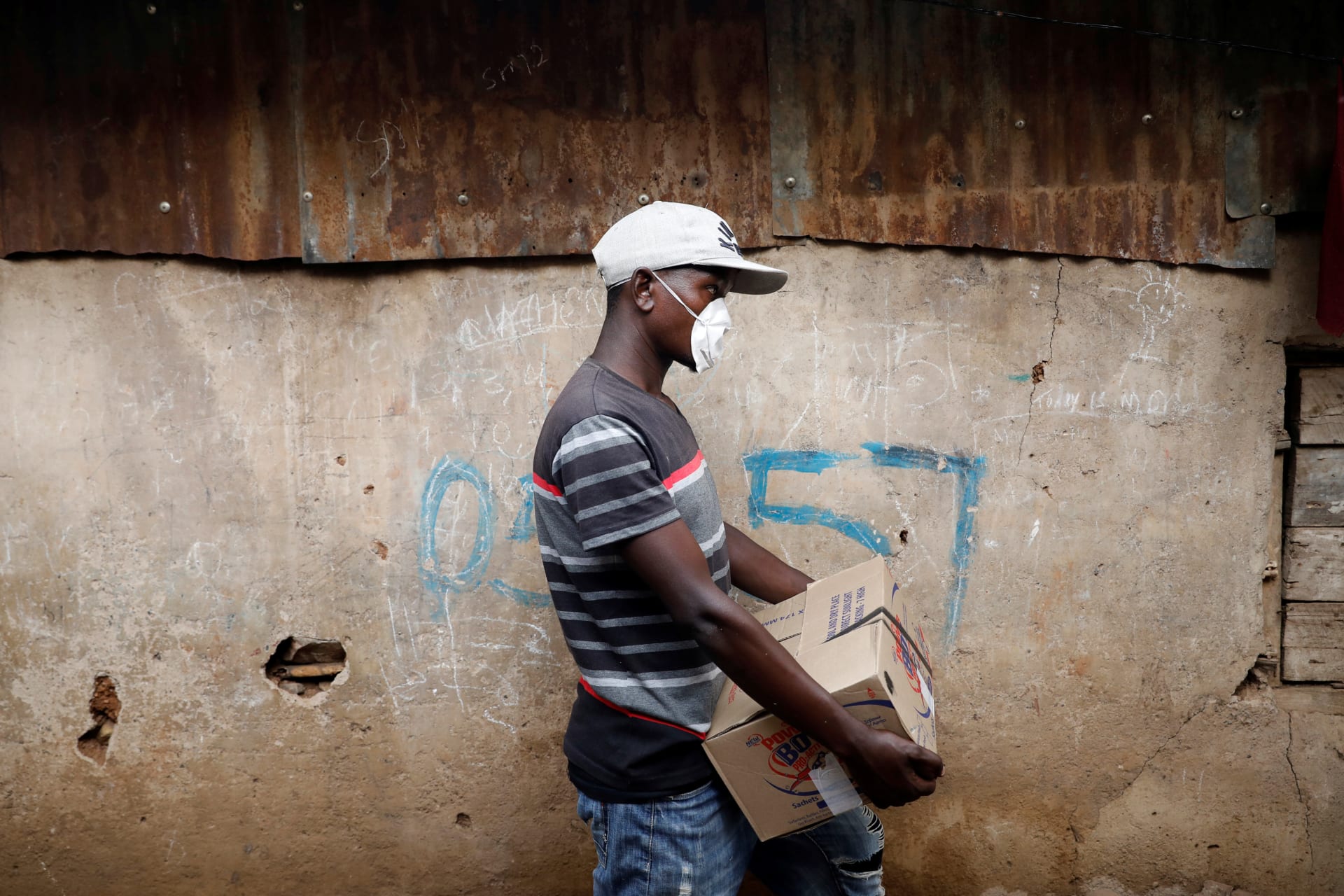 <p>A community activist holds a box with donations to be distributed to people in need in Nairobi, Kenya, on April 14, 2020</p>