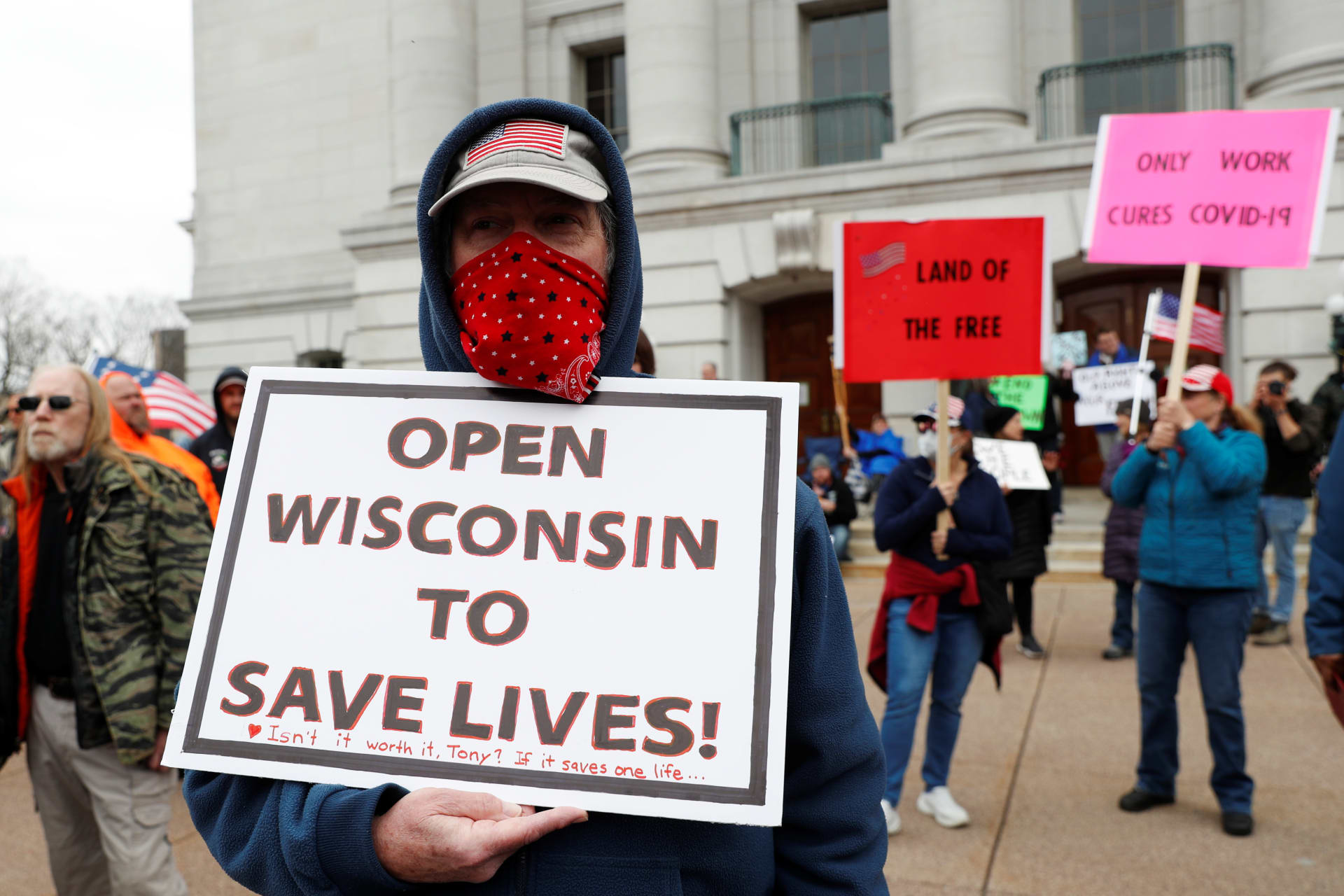 <p>A demonstrator protests the extension of the emergency Safer at Home order by State Governor Tony Evers to slow the spread of the coronavirus disease.</p>
