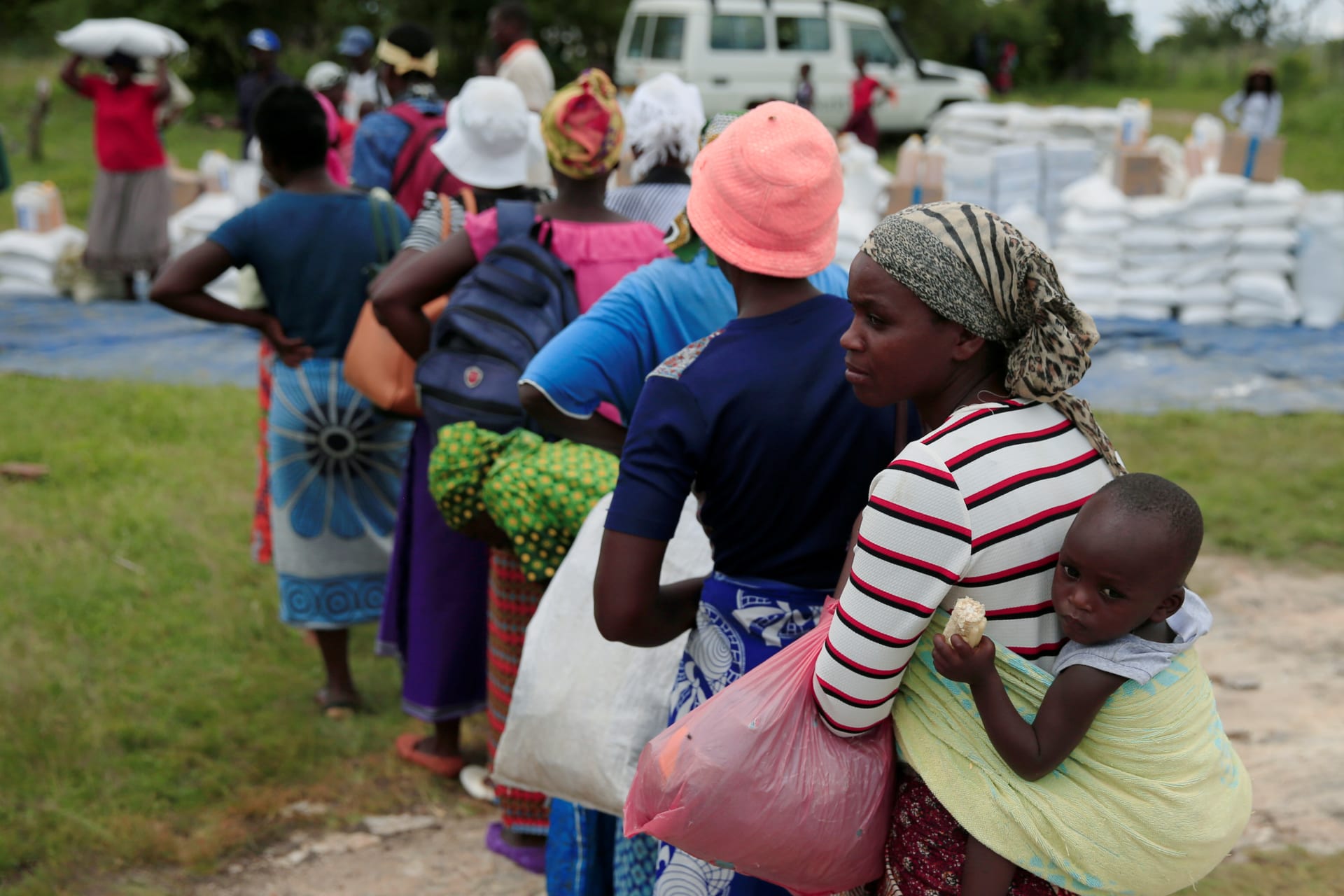 <p>Villagers queue to collect food aid distributed by the World Food Program (WFP) following a prolonged drought in rural Mudzi district, Zimbabwe, February 20, 2020</p>
