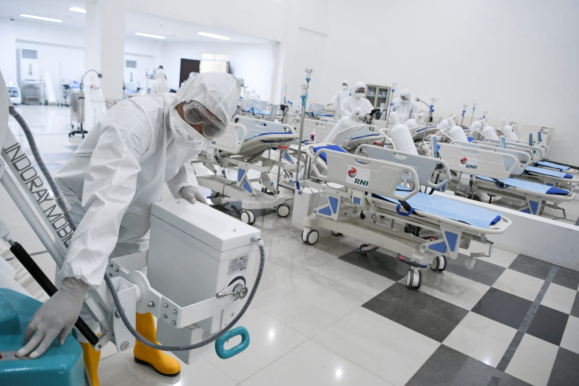<p>A medical officer checks devices at an emergency hospital.</p>
