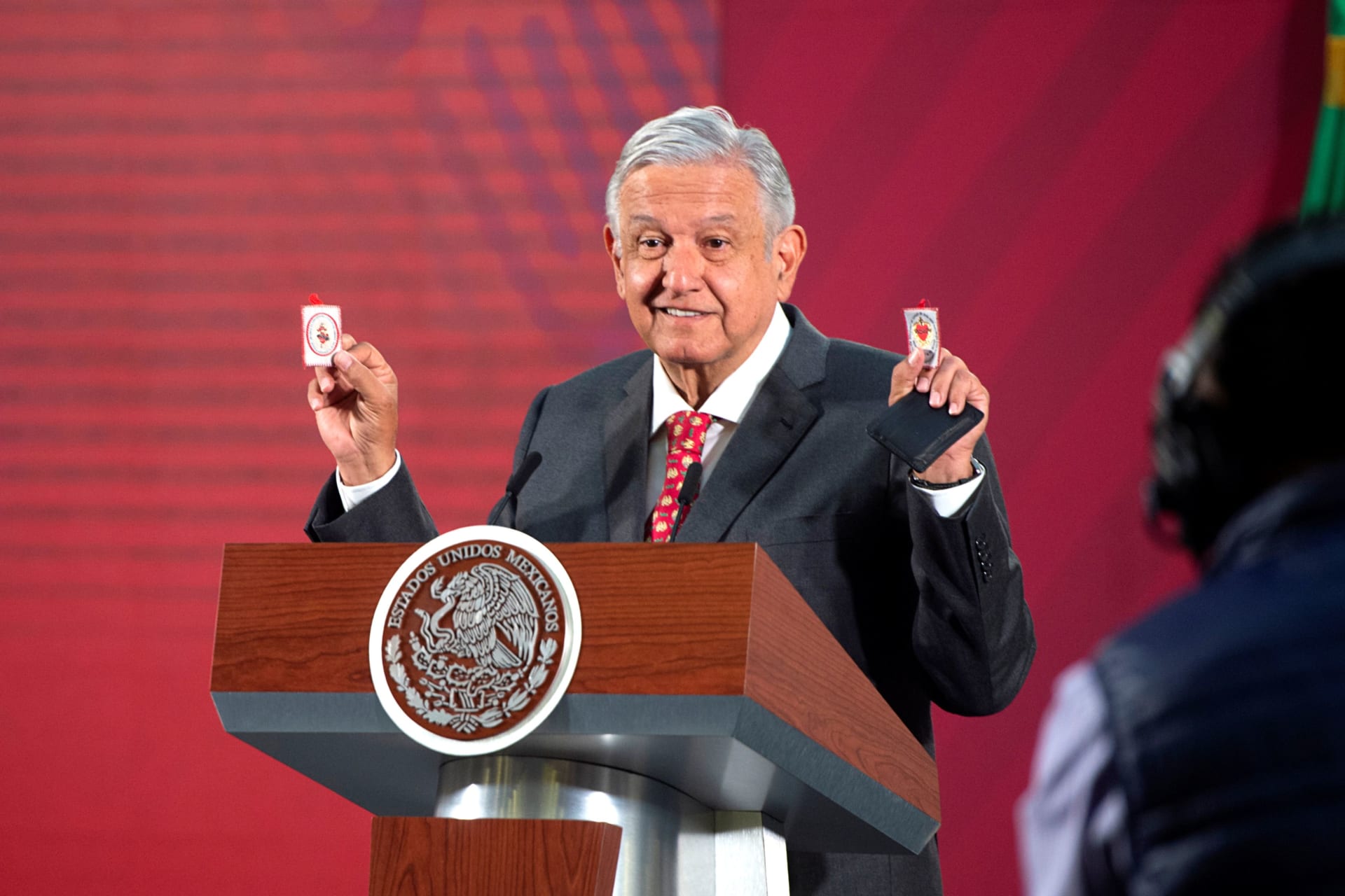 <p>Mexico’s President Andres Manuel Lopez Obrador shows his amulets, which he says serves him as a “protective shield” against the coronavirus disease (COVID-19) along with his honesty and not allowing corruption, during a news conference.</p>
