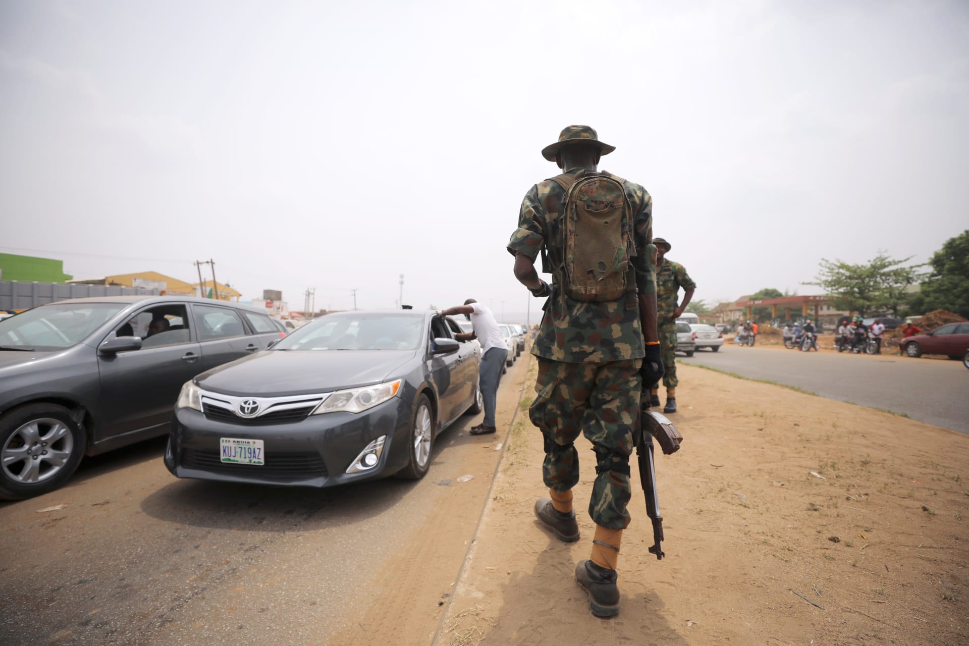 <p>A soldier observes temperature checks at the border between Abuja and Nasarawa states in Nigeria, as the authorities try to limit the spread of the coronavirus disease (COVID-19), on March 30, 2020. </p>
