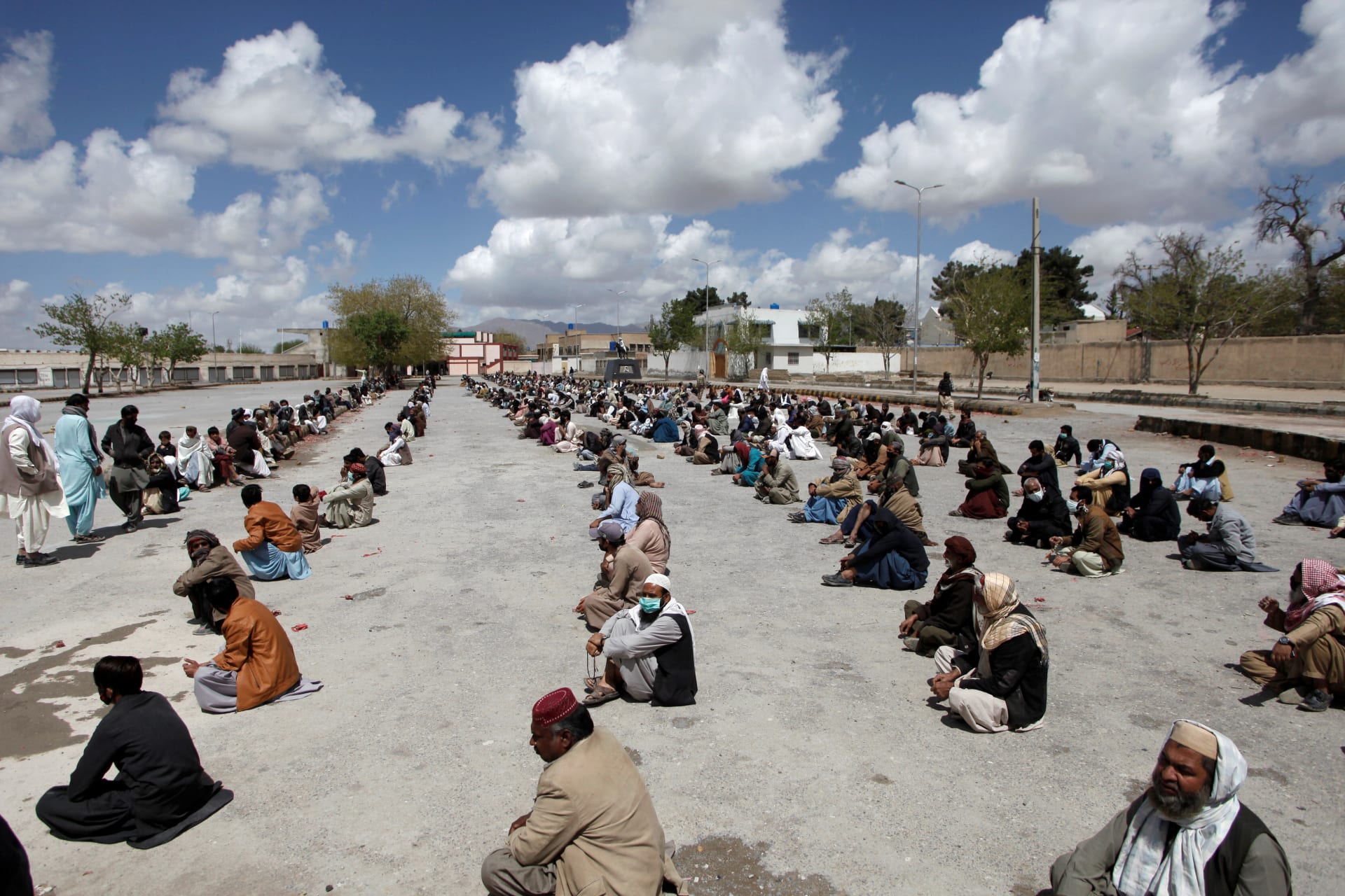 <p>People in Quetta, Pakistan wait for ration handouts from a charity during a national lockdown</p>
