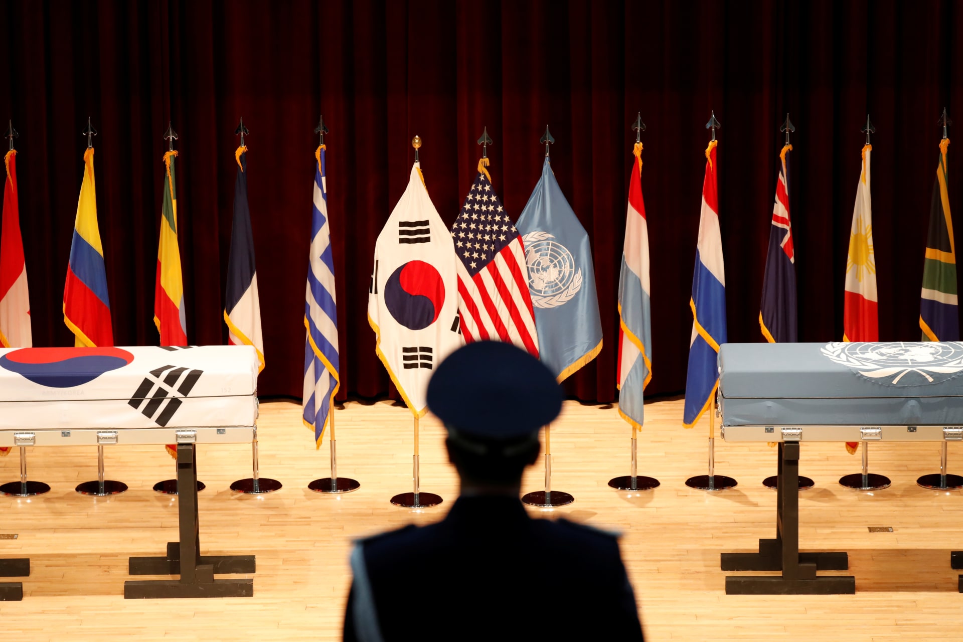 <p>A South Korean honor guard stands in front of boxes containing the remains of the UNC and ROK soldiers killed in North Korea in the 1950-53 Korean War during the mutual repatriation ceremony of soldiers’ remains in Seoul, South Korea on July 13, 2018.</p>
