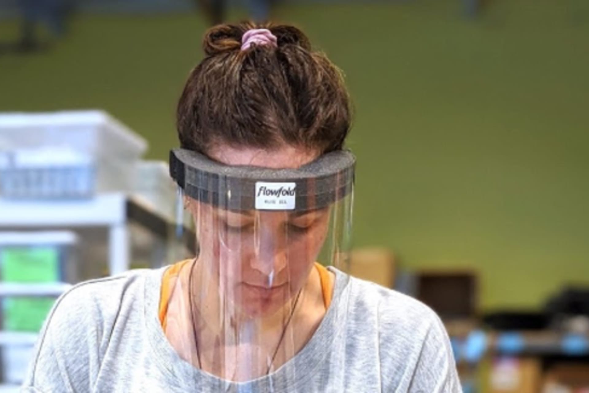 <p>A worker at Flowfold using one of their newly designed masks on the production line.</p>
