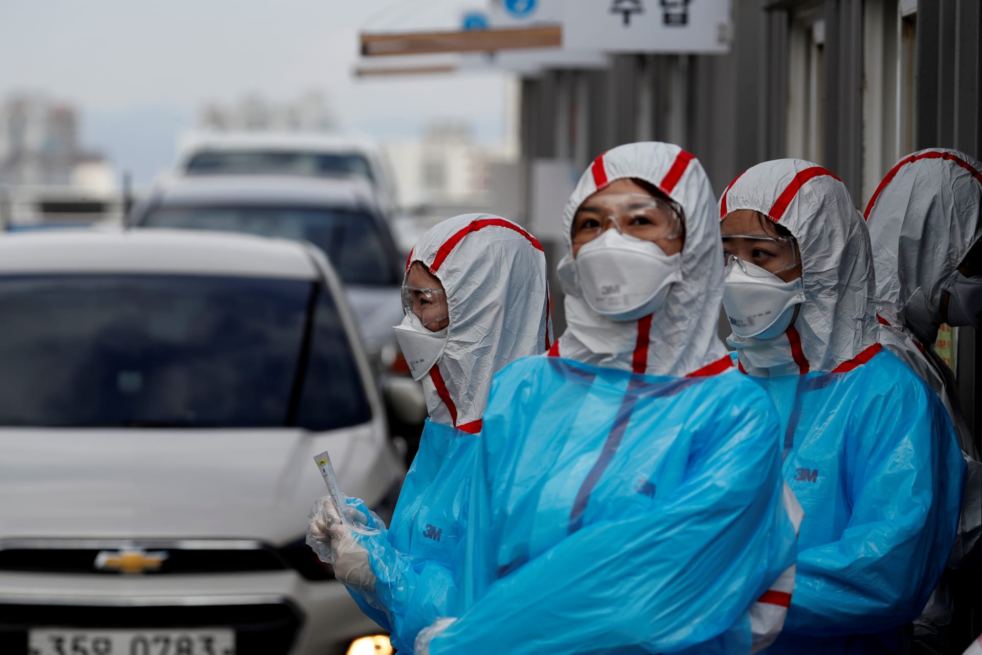 <p>Medical staff in protective gear work at a ‘drive-thru’ testing center for COVID-19 in Yeungnam University Medical Center in Daegu, South Korea, on March 3, 2020.</p>
