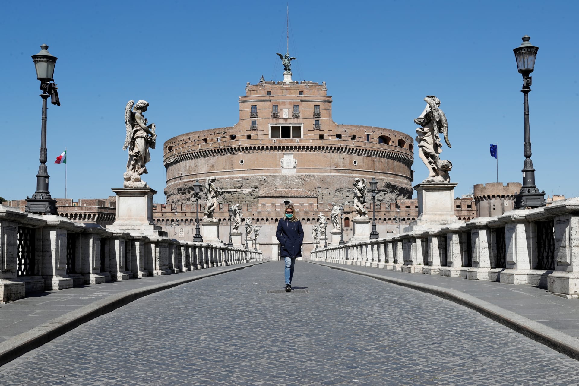 <p>A woman wearing a protective mask outside Castel Sant’Angelo. Italy has tightened measures to try and contain the spread of COVID-19 (coronavirus). Rome, Italy. March 23, 2020.</p>

