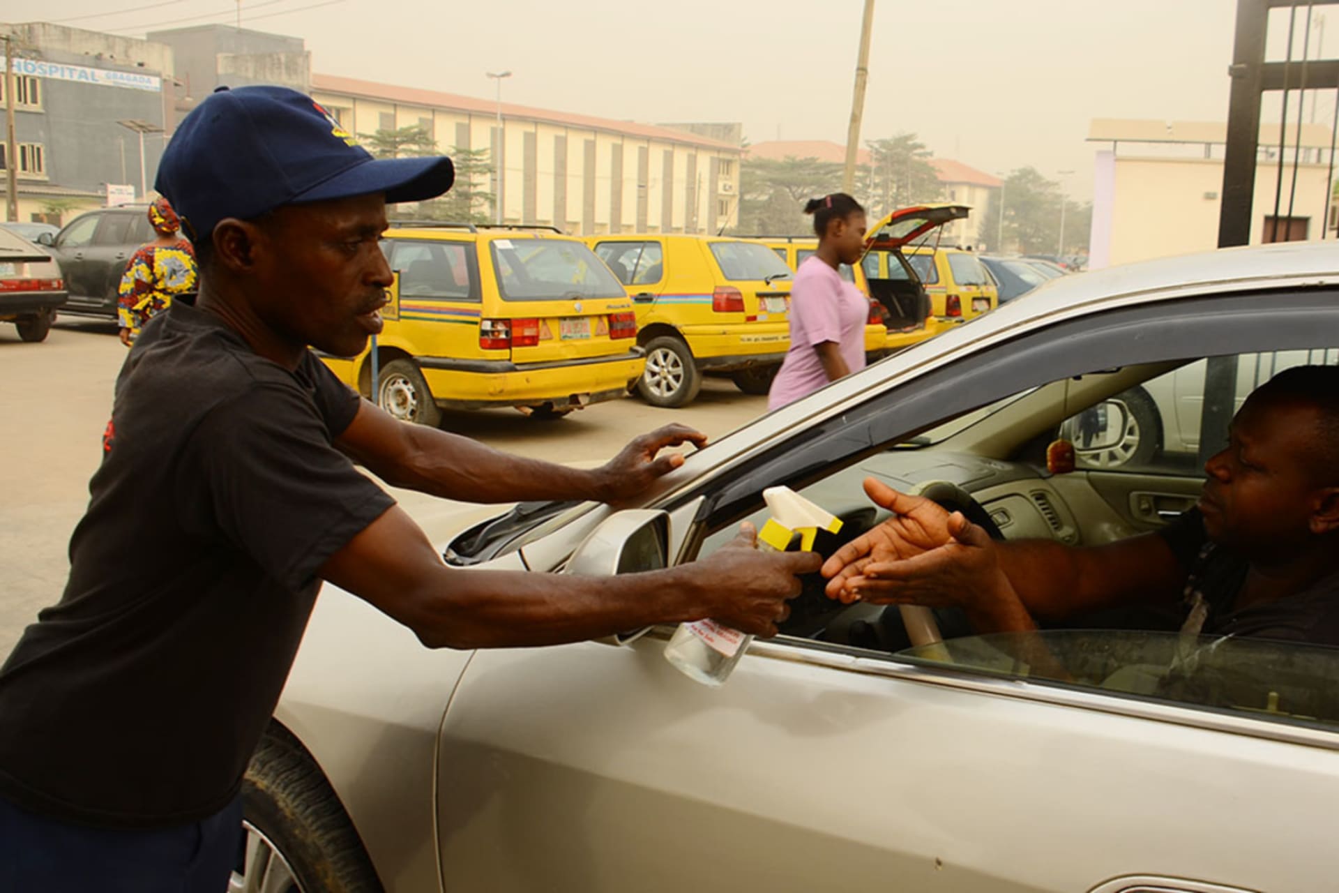 <p>A Nigerian Security and Civil Defence Corps official spray a man hand with hand sanitizer in front of Gbagada General Hospital, after Lassa fever outbreak death toll hits 70 in Nigeria, in Lagos February 14, 2020.</p>
