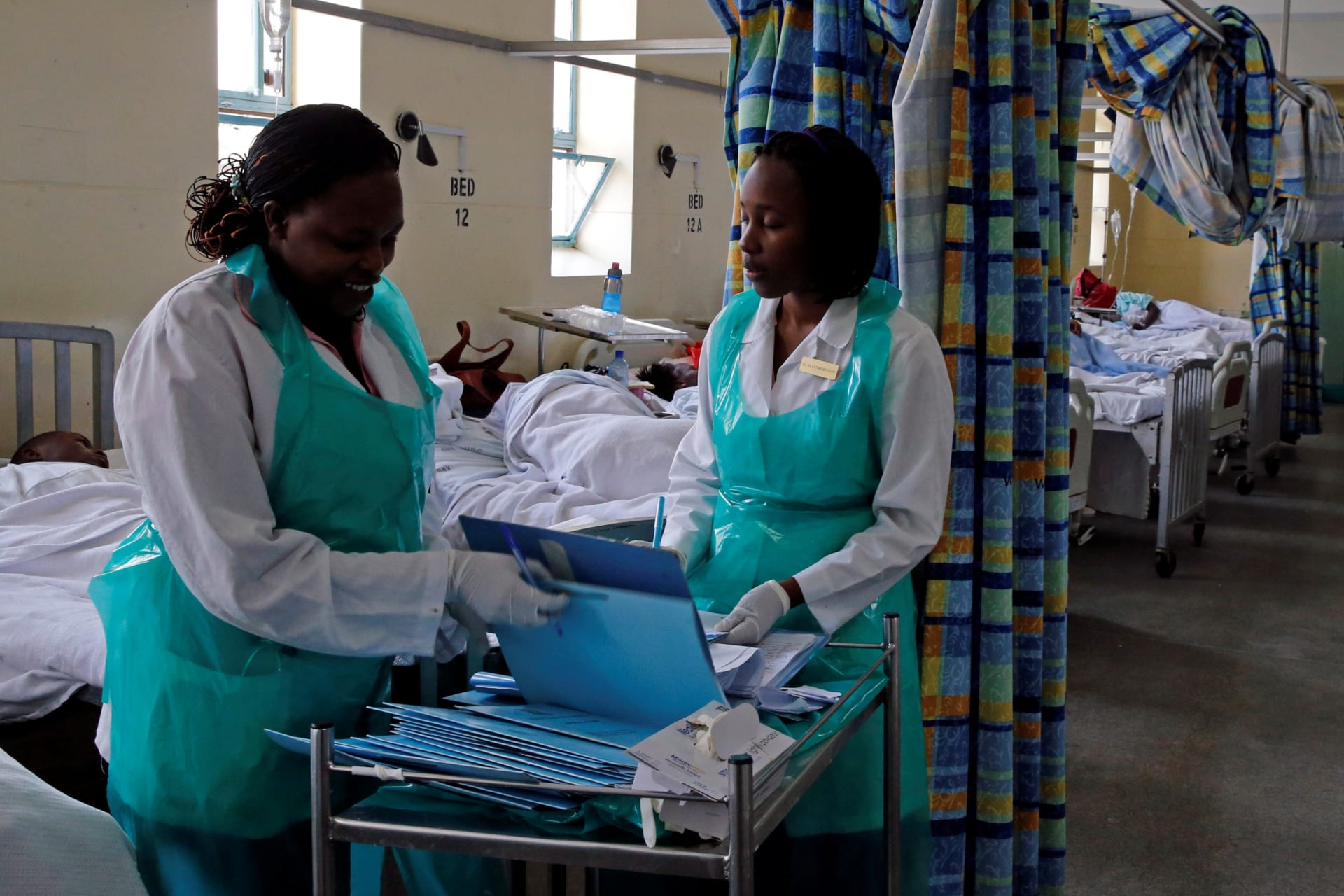 <p>Medical practitioners organize records inside a ward set aside for cholera patients at the Kenyatta National Hospital in Nairobi, Kenya, on July 19, 2017.</p>
