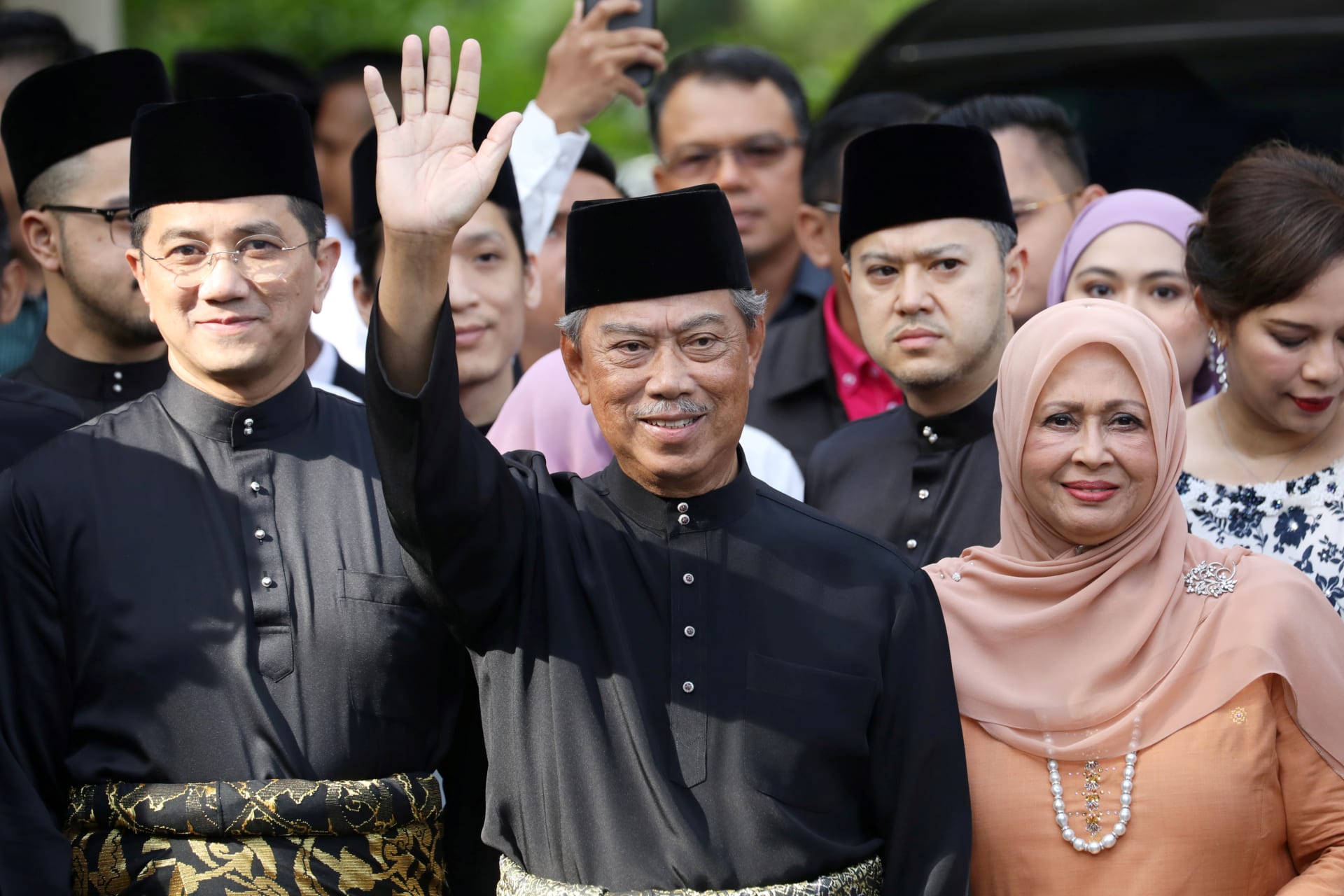 <p>Malaysia’s Prime Minister Designate and former interior minister Muhyiddin Yassin waves to reporters before his inauguration as the eighth prime minister, outside his residence in Kuala Lumpur, Malaysia, on March 1, 2020.</p>
