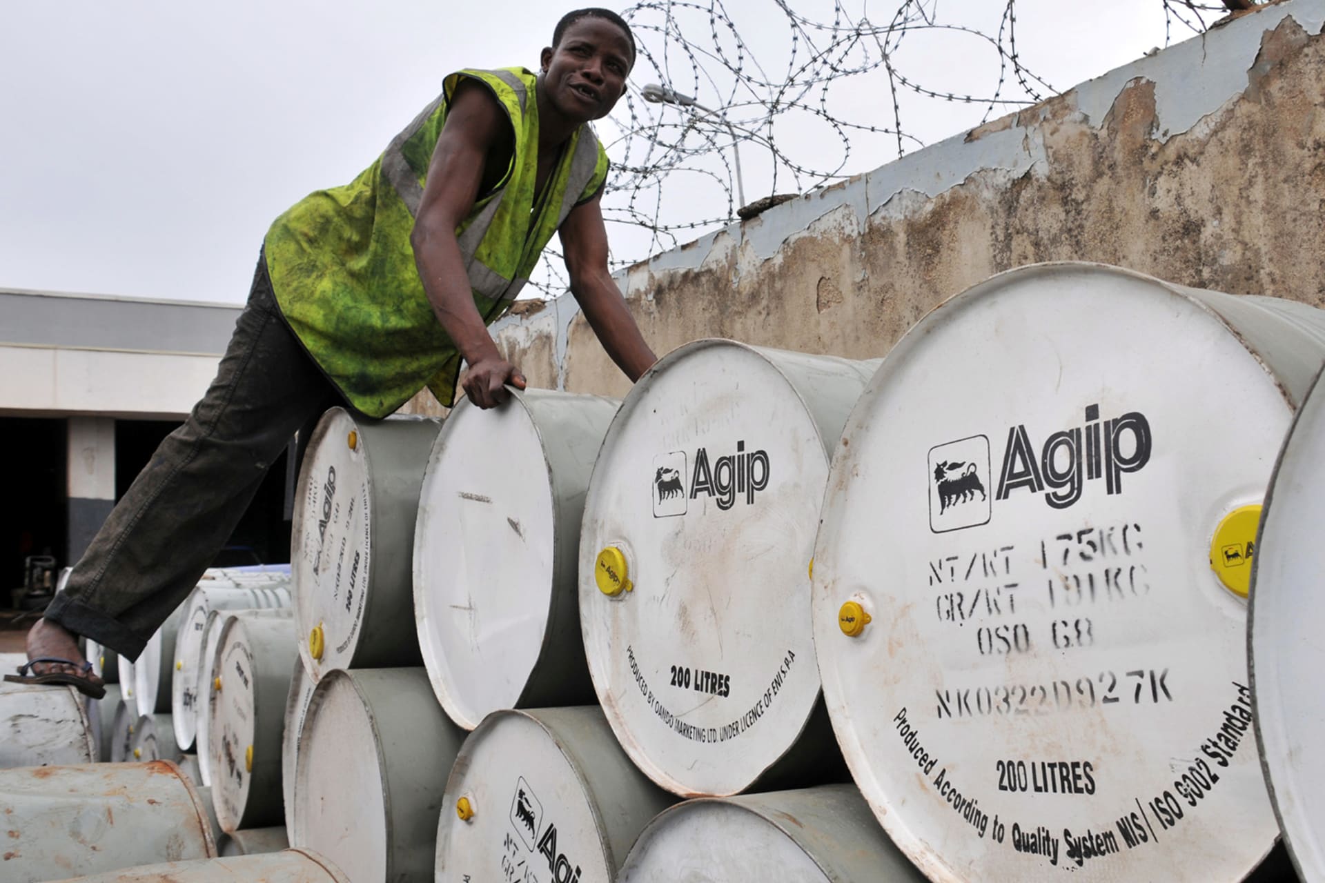 <p>A man arranges Agip drums at an oil station and depot in Nigeria’s capital Abuja, on June 19, 2009.</p>
