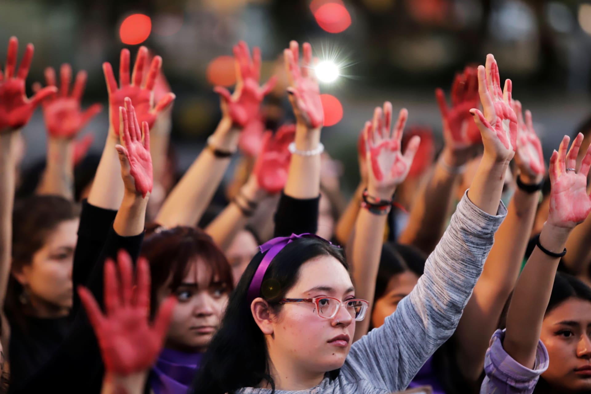 <p>Women raise their hands as they protest against gender violence and femicide in Puebla, Mexico, February 22, 2020.</p>
