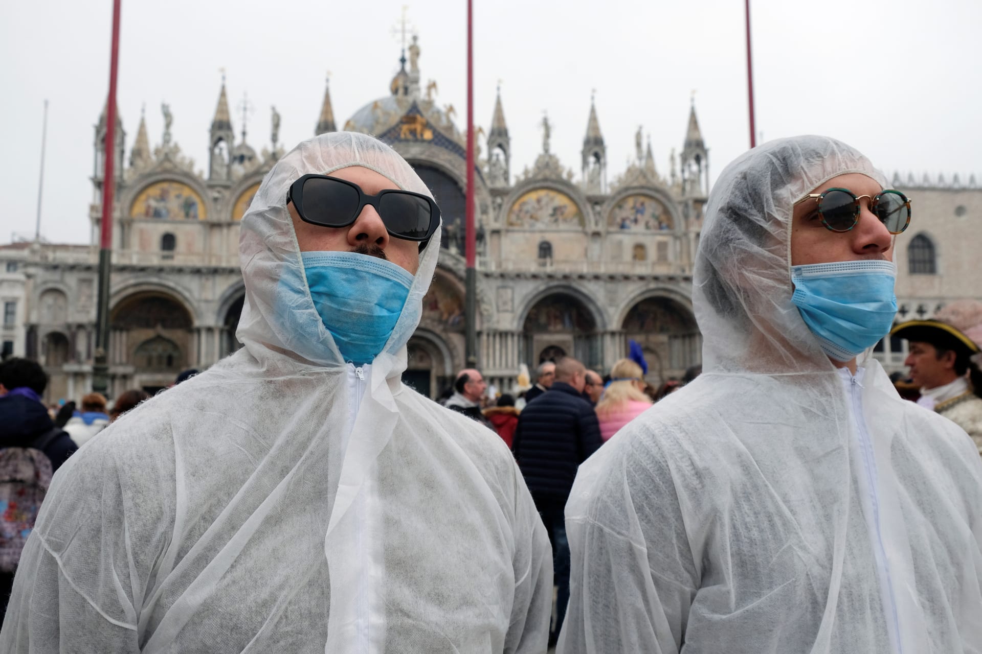 <p>Tourists wear protective face masks at Venice Carnival, which has been cancelled because of an outbreak of coronavirus, in Venice, Italy on February 23, 2020. </p>
