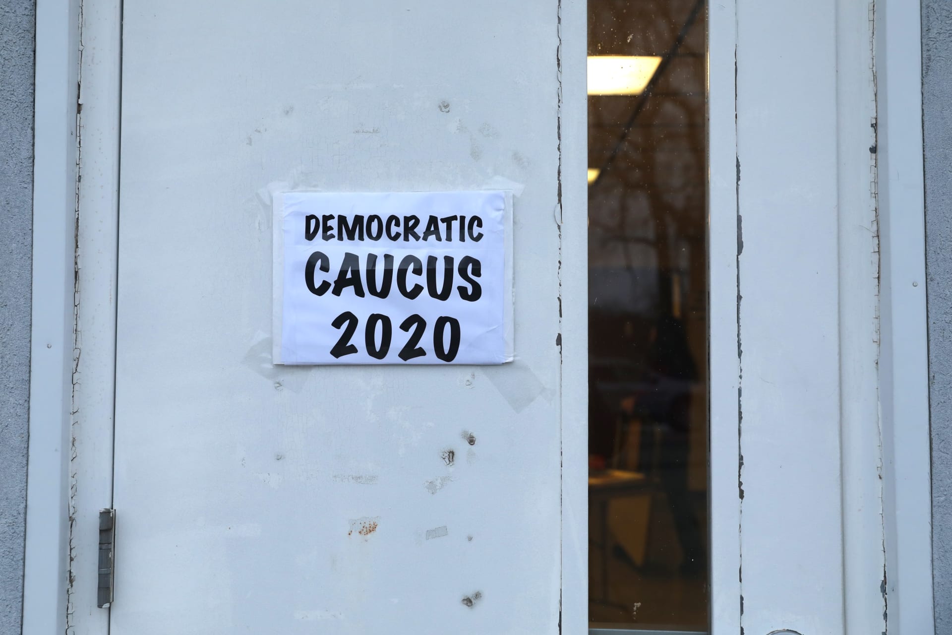 <p>A sign is seen on a caucus doorway in Kellogg., Iowa, U.S.</p>