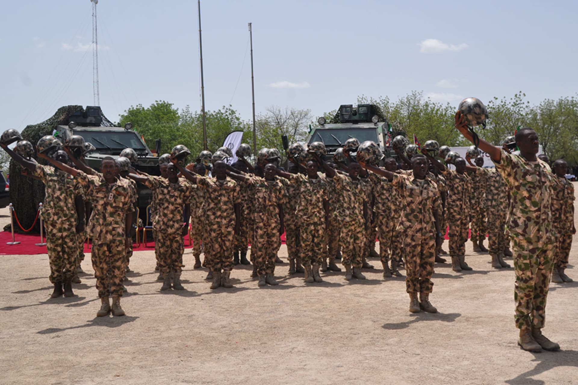 <p>Nigerian soldiers salute during a visit by President in Maiduguri, on July 6, 2018, during the celebrations for Nigeria Army day. </p>
