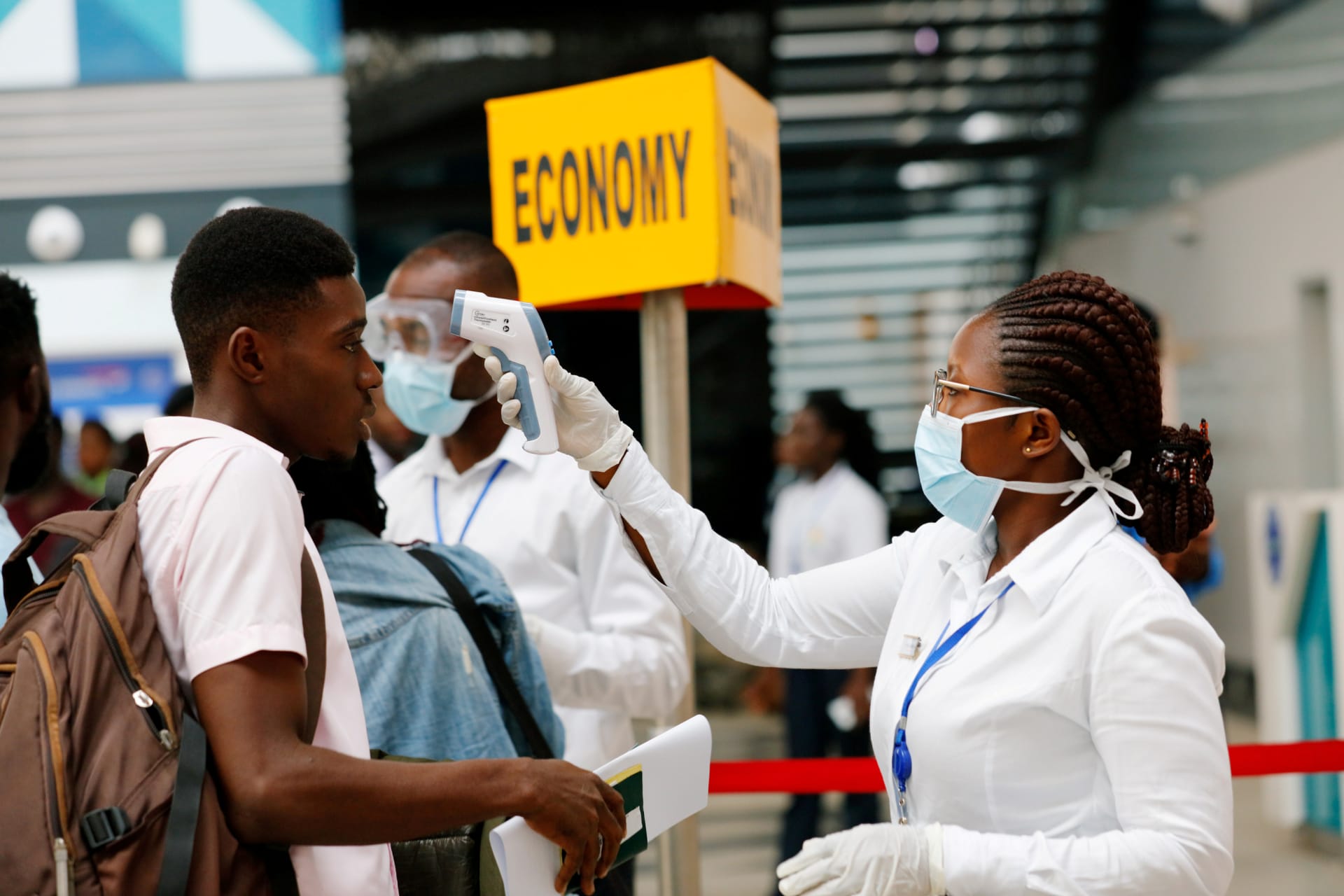 <p>A health worker checks the temperature of a traveller as part of the coronavirus screening procedure at the Kotoka International Airport in Accra, Ghana, on January 30, 2020. </p>
