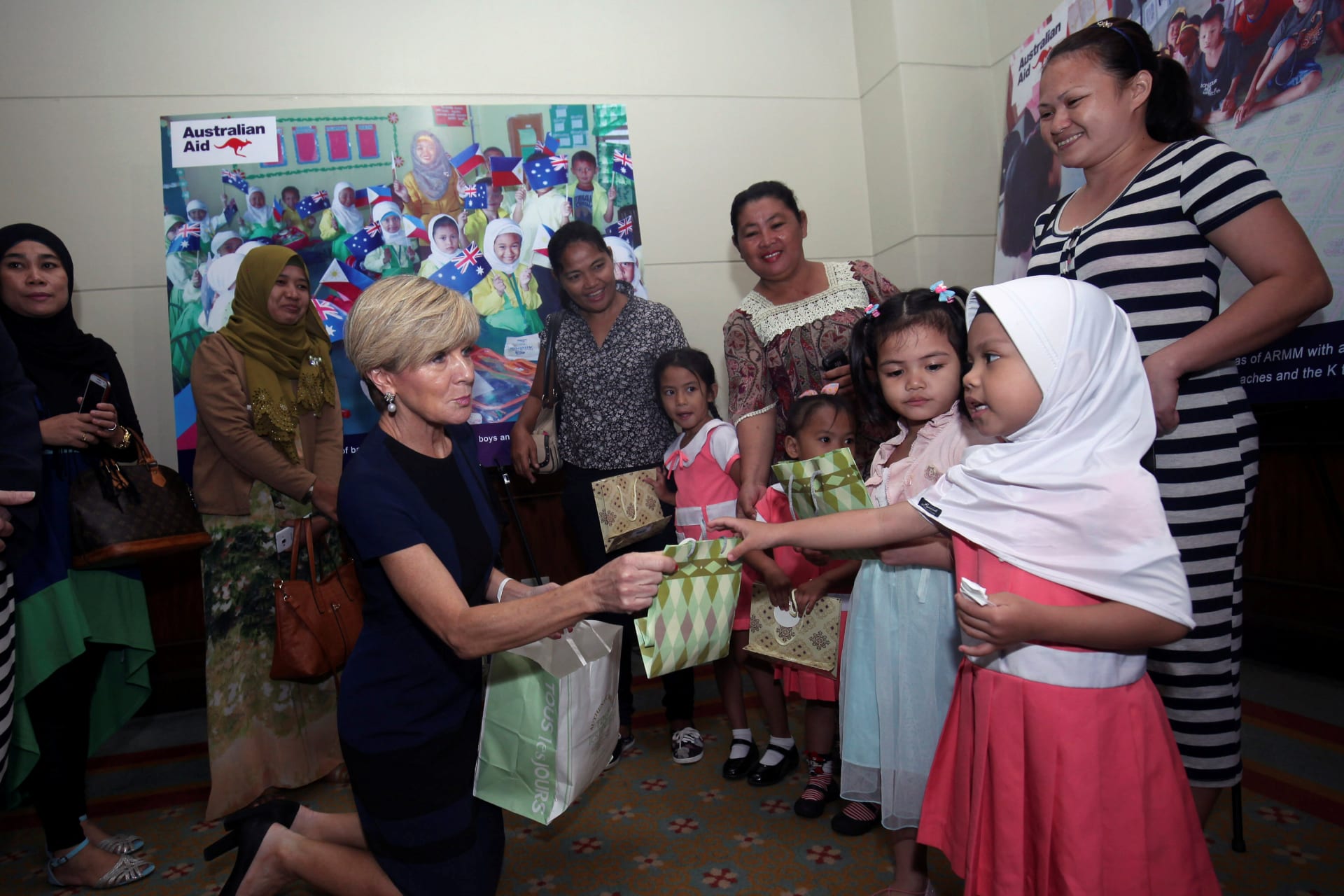 <p>Australian Foreign Affairs Minister Julie Bishop hands over a gift to girls from the Autonomous Region of Muslim Mindanao (ARMM) during a visit in Davao city, Philippines.</p>
