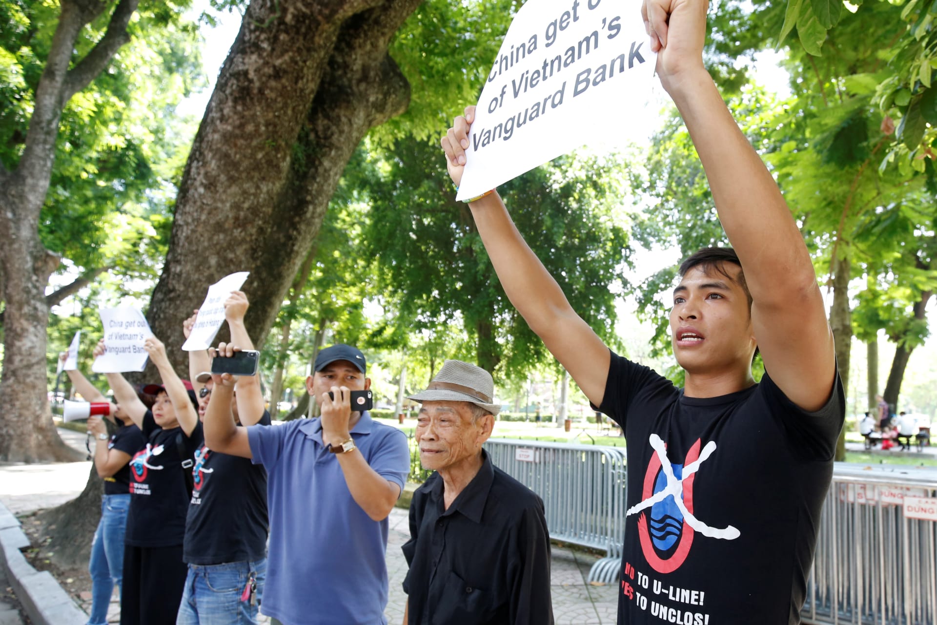 <p>Anti-China protesters hold placards during a demonstration in front of the Chinese embassy in Hanoi, Vietnam on August 6, 2019.</p>
