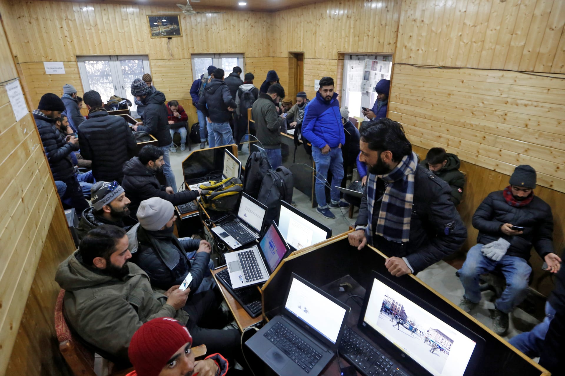 <p>Journalists use the internet as they work inside a government-run media centre in Srinagar</p>

