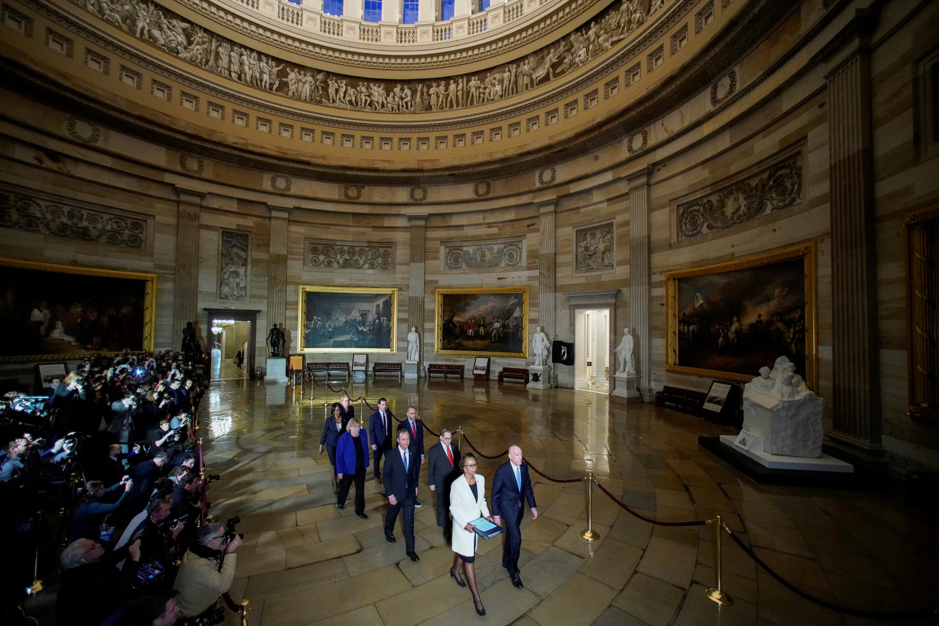 <p>The House Sergeant and House Clerk carry the articles of impeachment during a procession with the seven House impeachment managers on January 15. Joshua Roberts/REUTERS </p>
