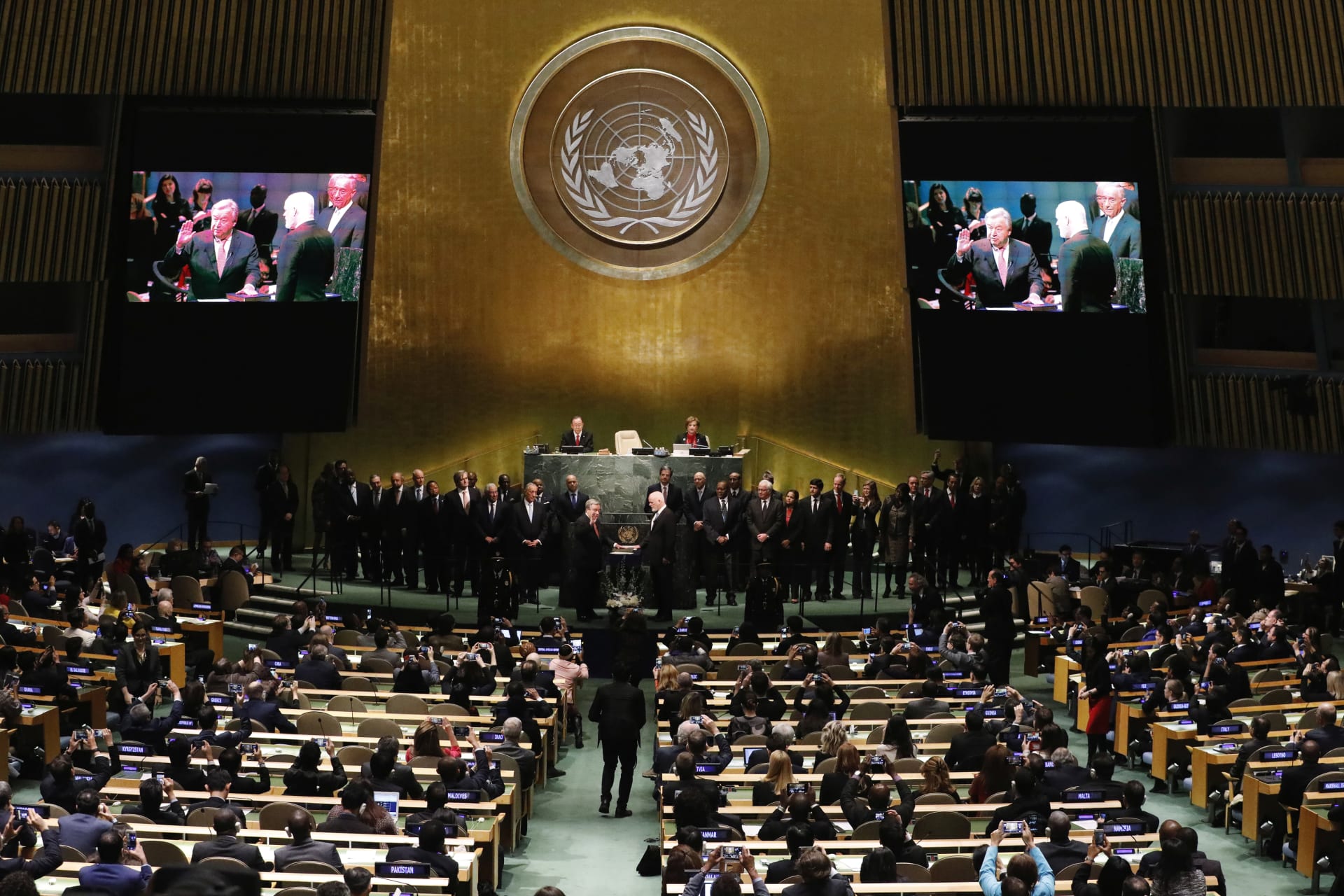 <p>United Nations Secretary-General Ban Ki-moon (back L) watches as Secretary-General-designate Mr. Antonio Guterres of Portugal is sworn in by President of the U.N. General Assembly Peter Thomson (R), at UN headquarters in New York, U.S.</p>
