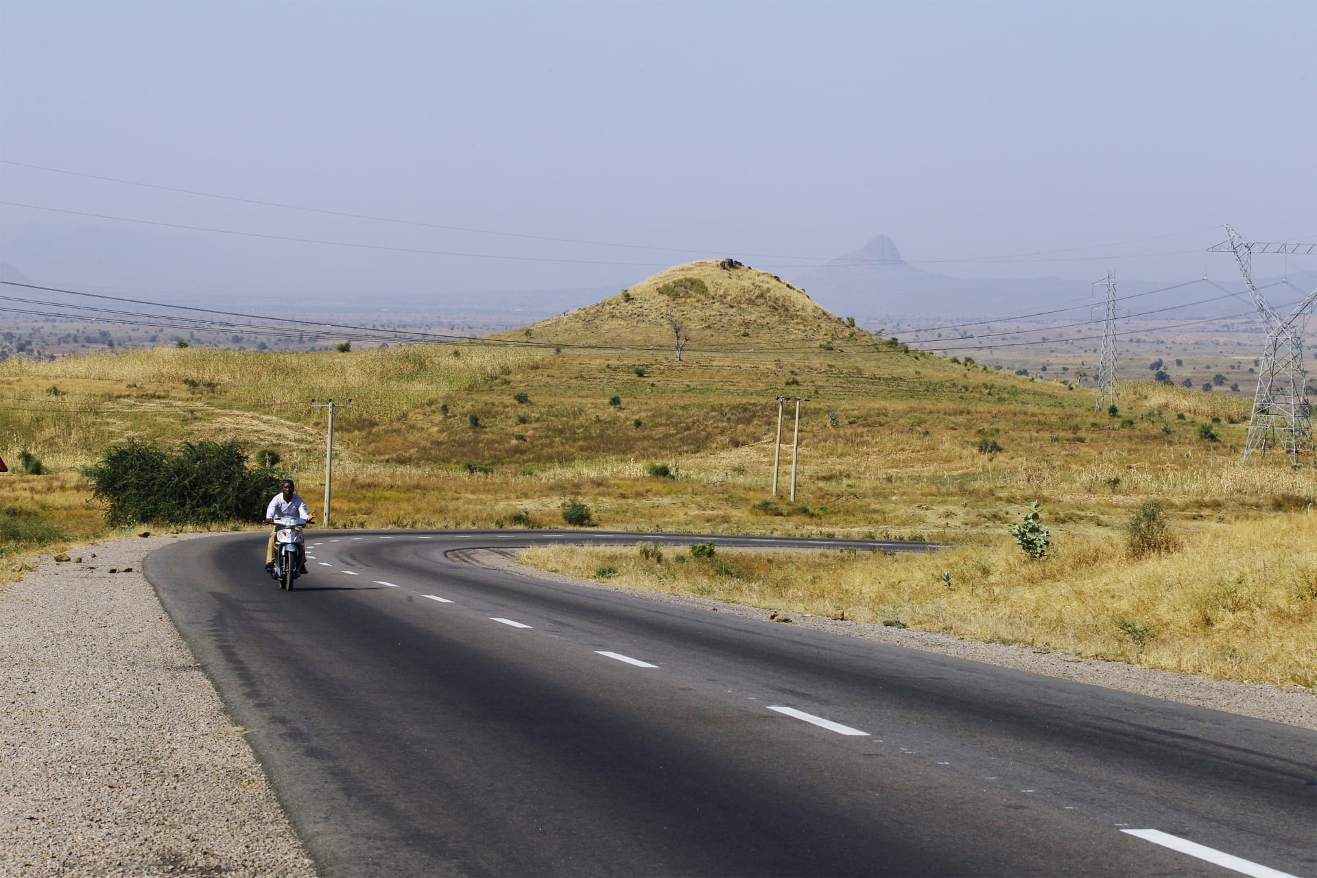 <p>A man rides his motorbike along Gombe Numan highway in Gombe state, on November 29, 2013.</p>
