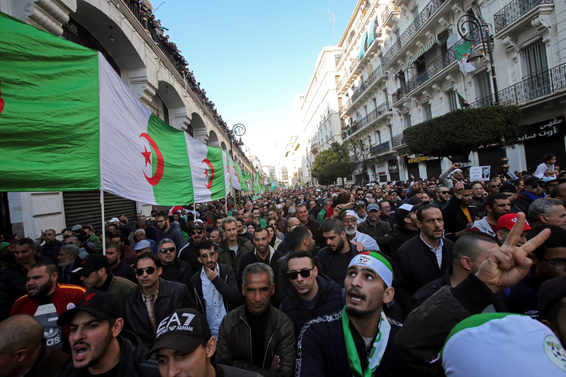 <p>Demonstrators carry a national flag during an anti-government rally in Algiers, Algeria January 3, 2020.</p>
