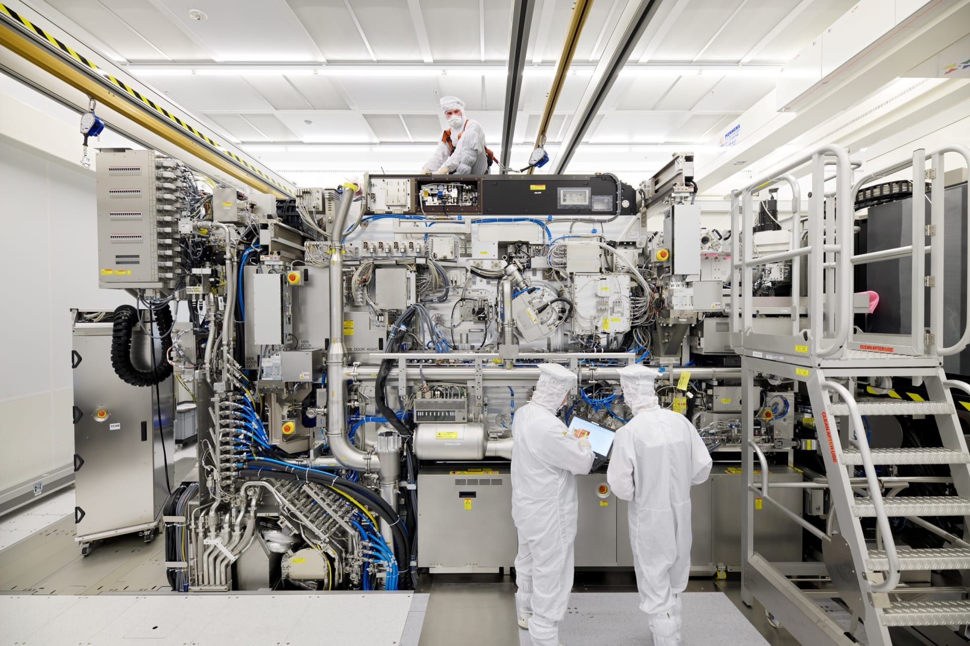 <p>Employees are seen working on the final assembly of ASML’s TWINSCAN NXE:3400B semiconductor lithography tool with its panels removed</p>
