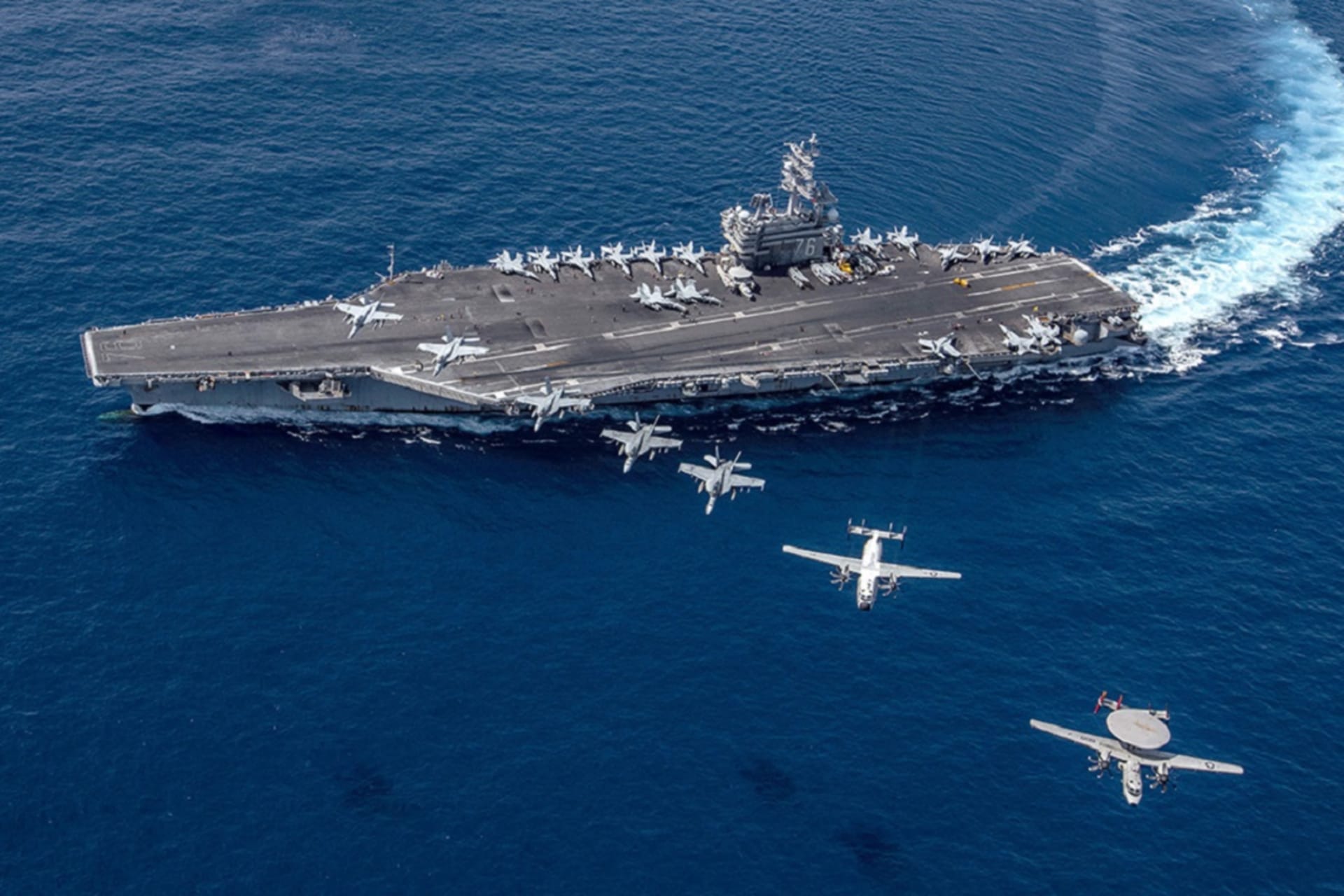 <p>Multiple aircraft fly in formation over the USS Ronald Reagan, a U.S. Navy aircraft carrier. (Kaila V. Peters/U.S. Navy)</p>

