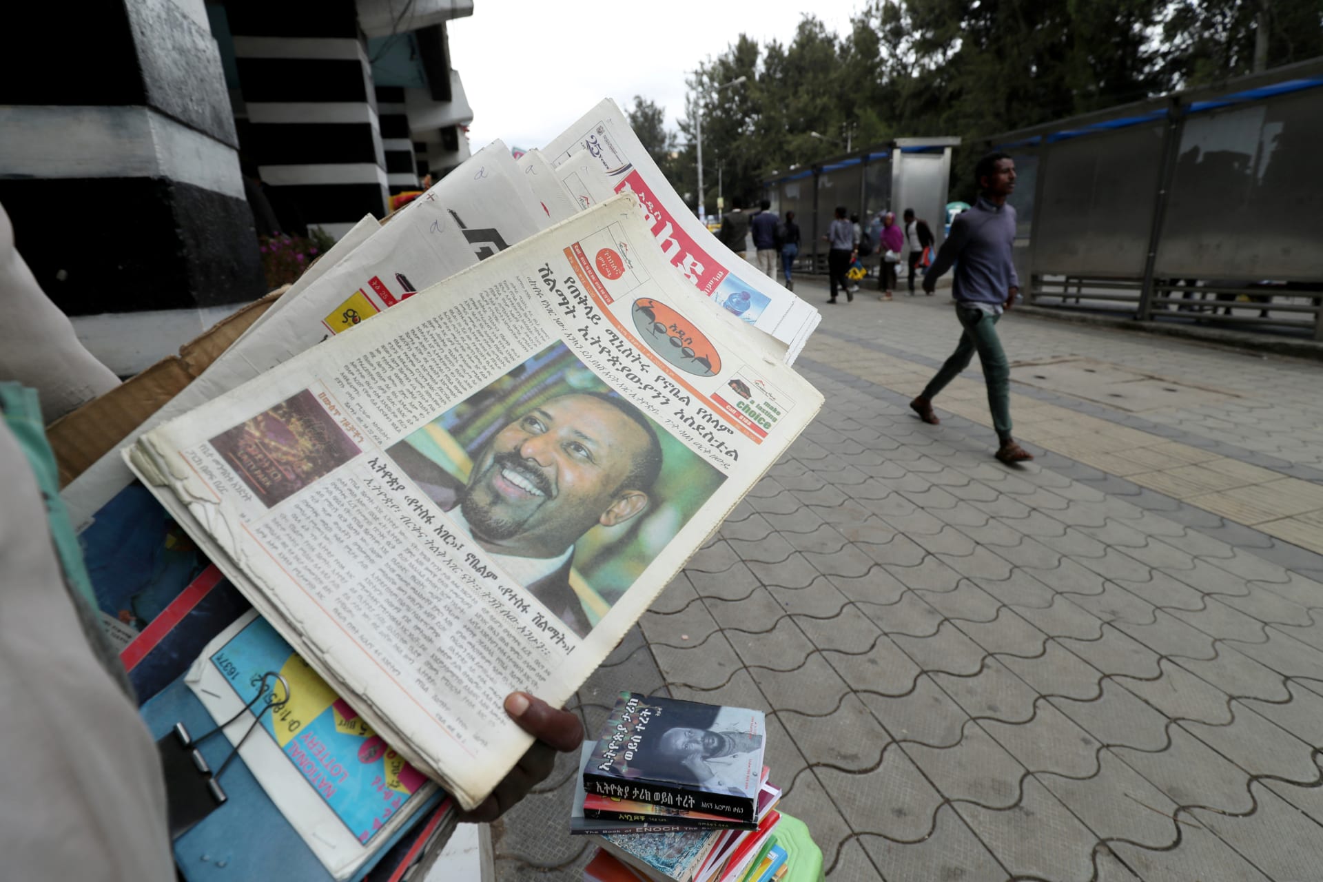 <p>A vendor sells a newspaper with a picture of Ethiopia’s Prime Minister, Abiy Ahmed on it’s cover in Addis Ababa, Ethiopia, December 10, 2019.</p>
