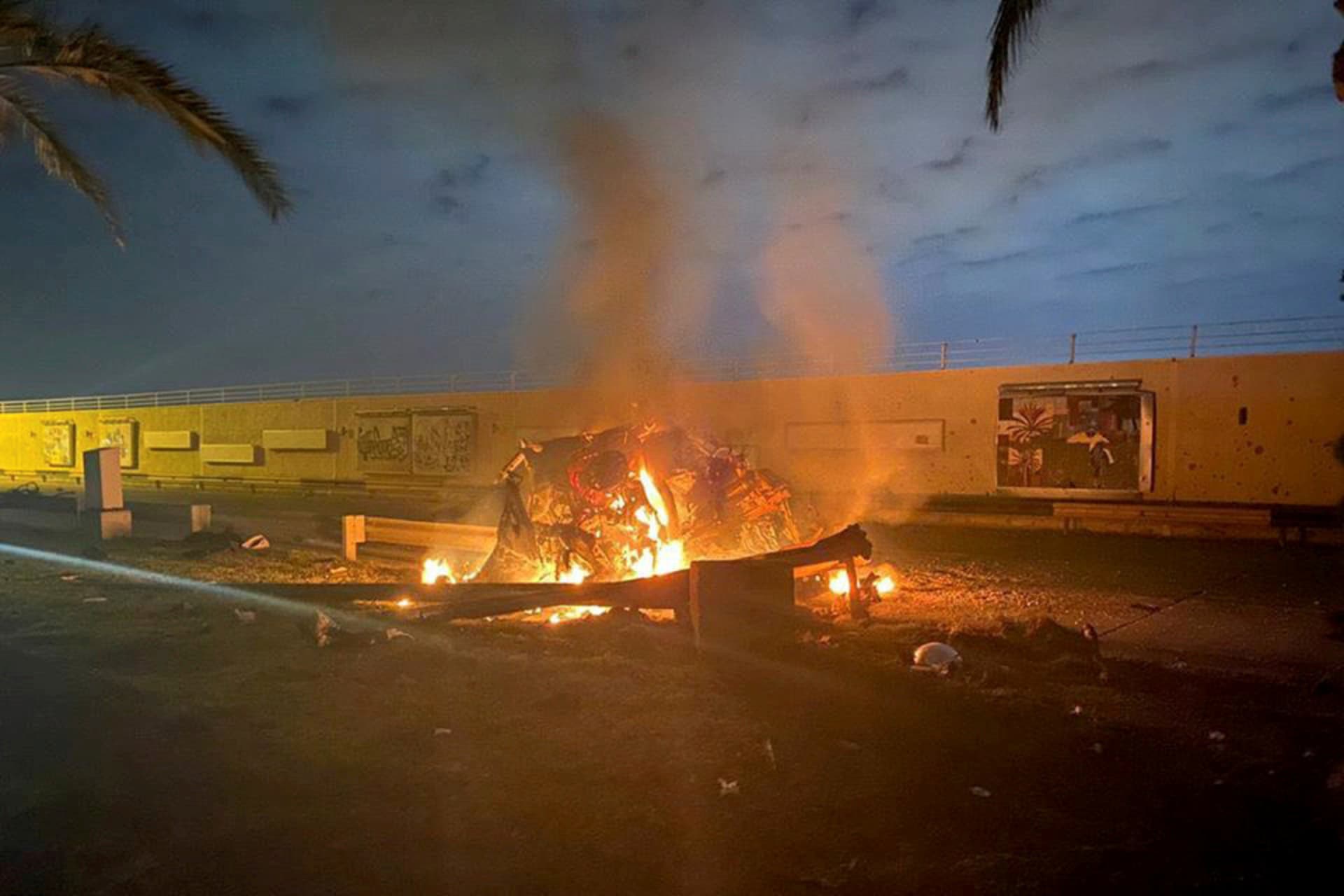 <p>Debris burns outside Baghdad International Airport where a U.S. drone strike killed Iranian commander Qasem Soleimani and seven others on January 3. </p>
