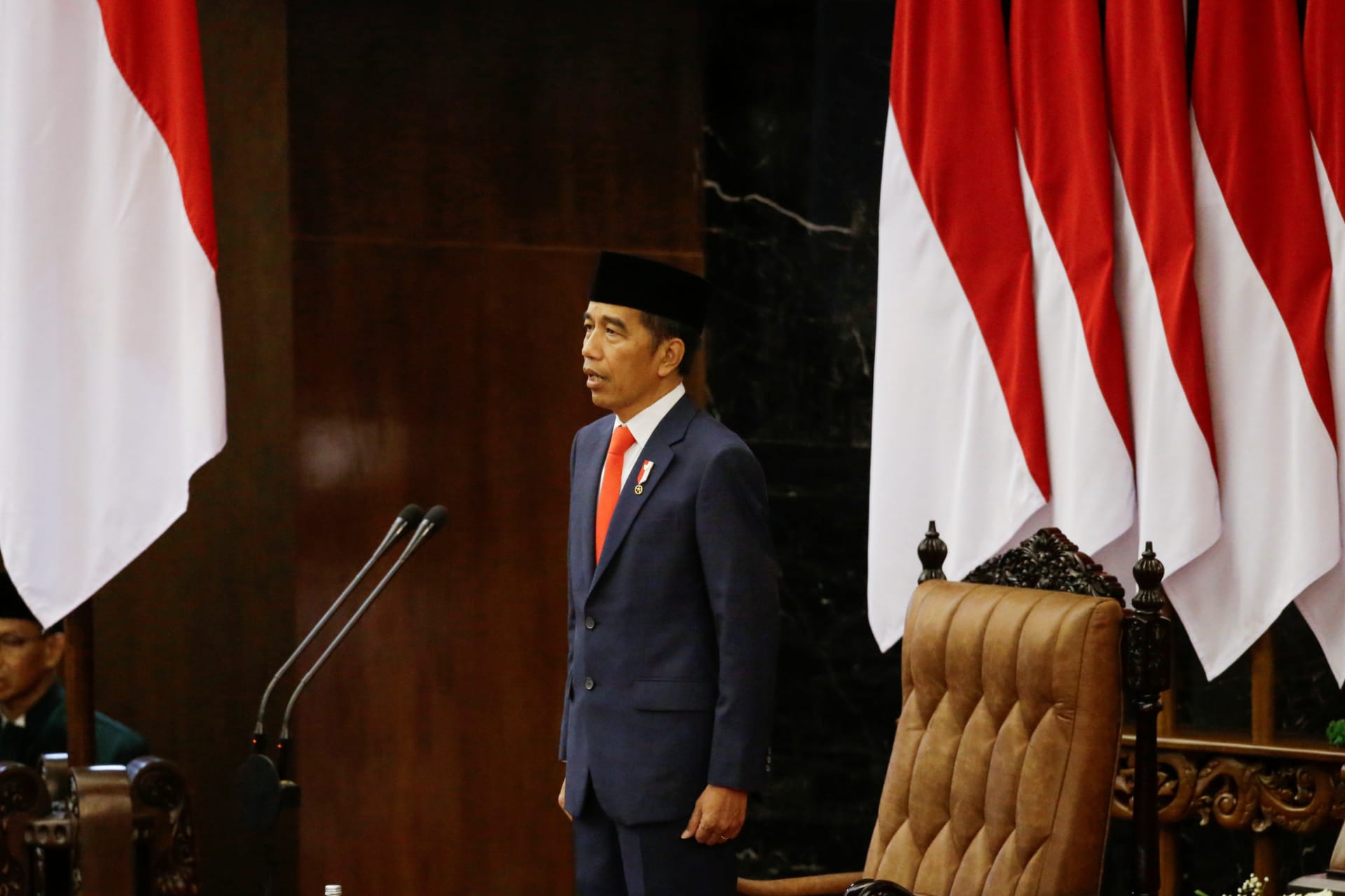 <p>Indonesian President Joko Widodo stands as he listens to the national anthem after taking an oath during his presidential inauguration for the second term, at the House of Representatives building in Jakarta, Indonesia, on October 20, 2019.</p>
