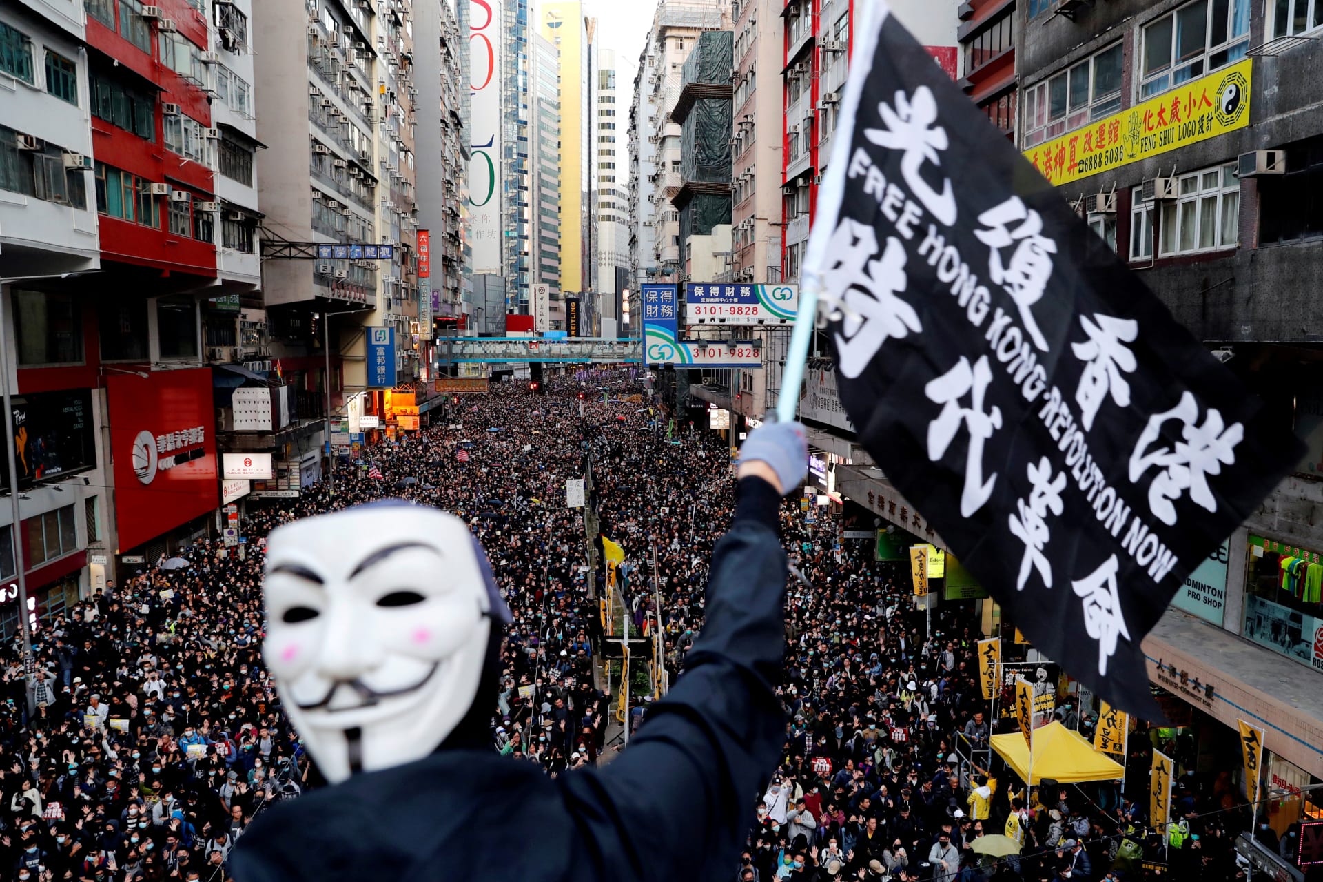 <p>A protester waves a flag during a Human Rights Day march in Hong Kong. Danish Siddiqui/REUTERS</p>
