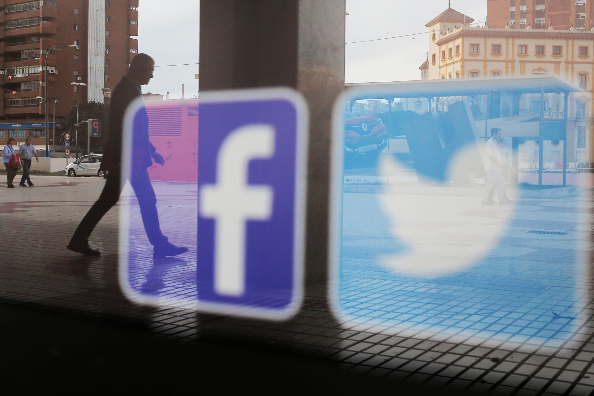 <p>Facebook and Twitter logos are seen on a shop window in Malaga, Spain</p>
