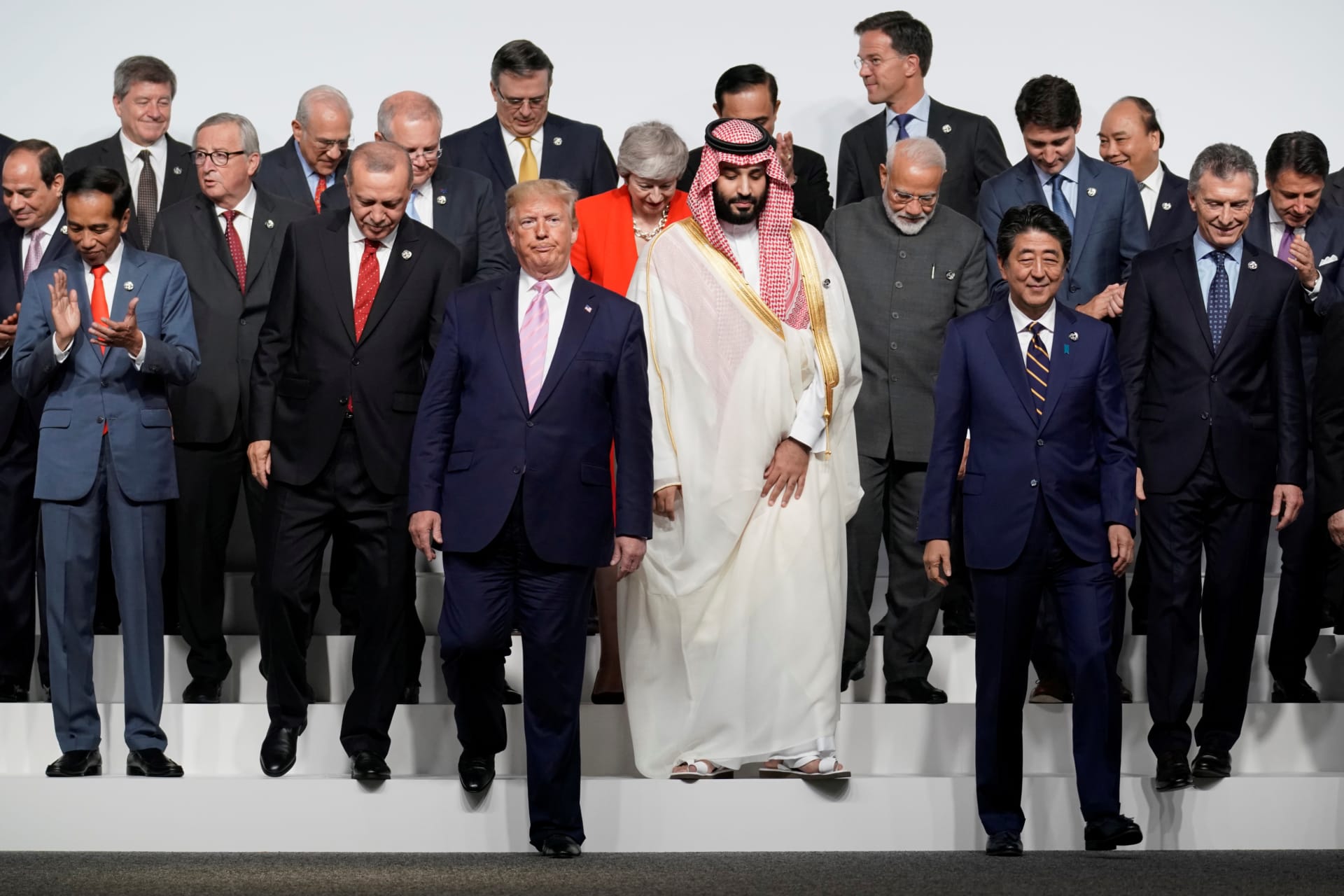<p>World leaders walk off after a family photo session at the G20 leaders summit in Osaka, Japan, on June 28, 2019.</p>
