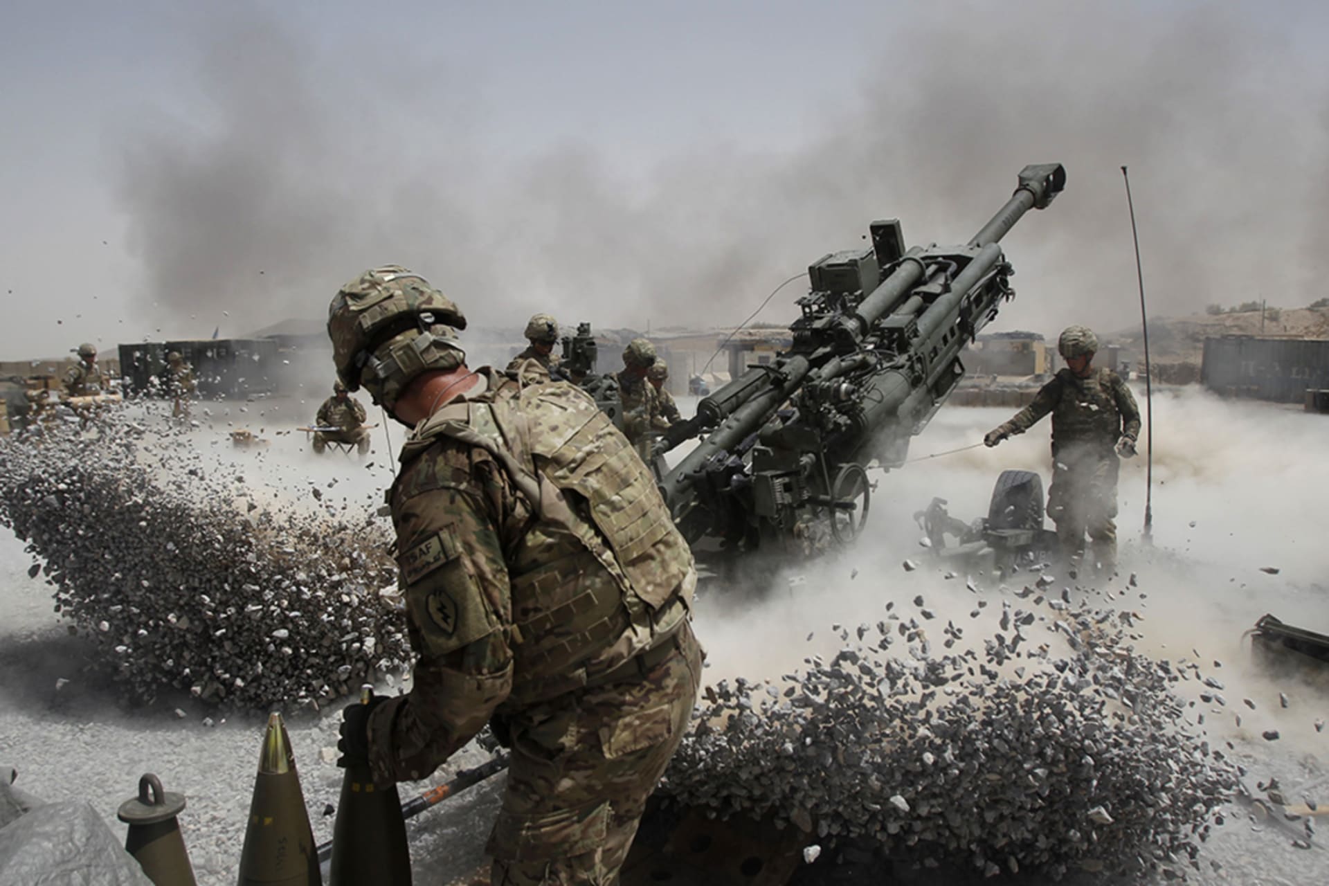 <p>U.S. Army soldiers fire a howitzer artillery piece in Kandahar Province on June 12, 2011.</p>
