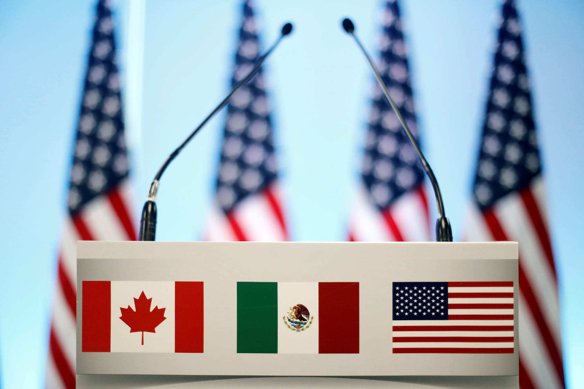 <p>The flags of Canada, Mexico, and the U.S. are seen on a lectern before a joint news conference on the closing of the seventh round of NAFTA talks in Mexico City, Mexico.</p>
