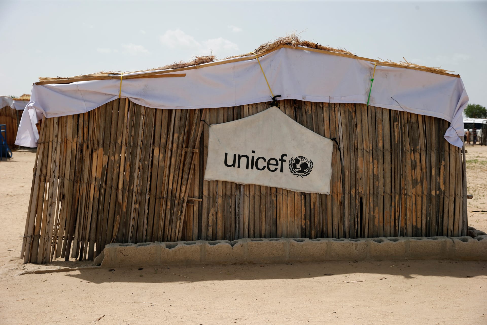 <p>A banner with the UNICEF logo is seen hanging on a makeshift school at an internally displaced persons camp on the outskirts of Maiduguri, northeast Nigeria, on June 6, 2017.</p>
